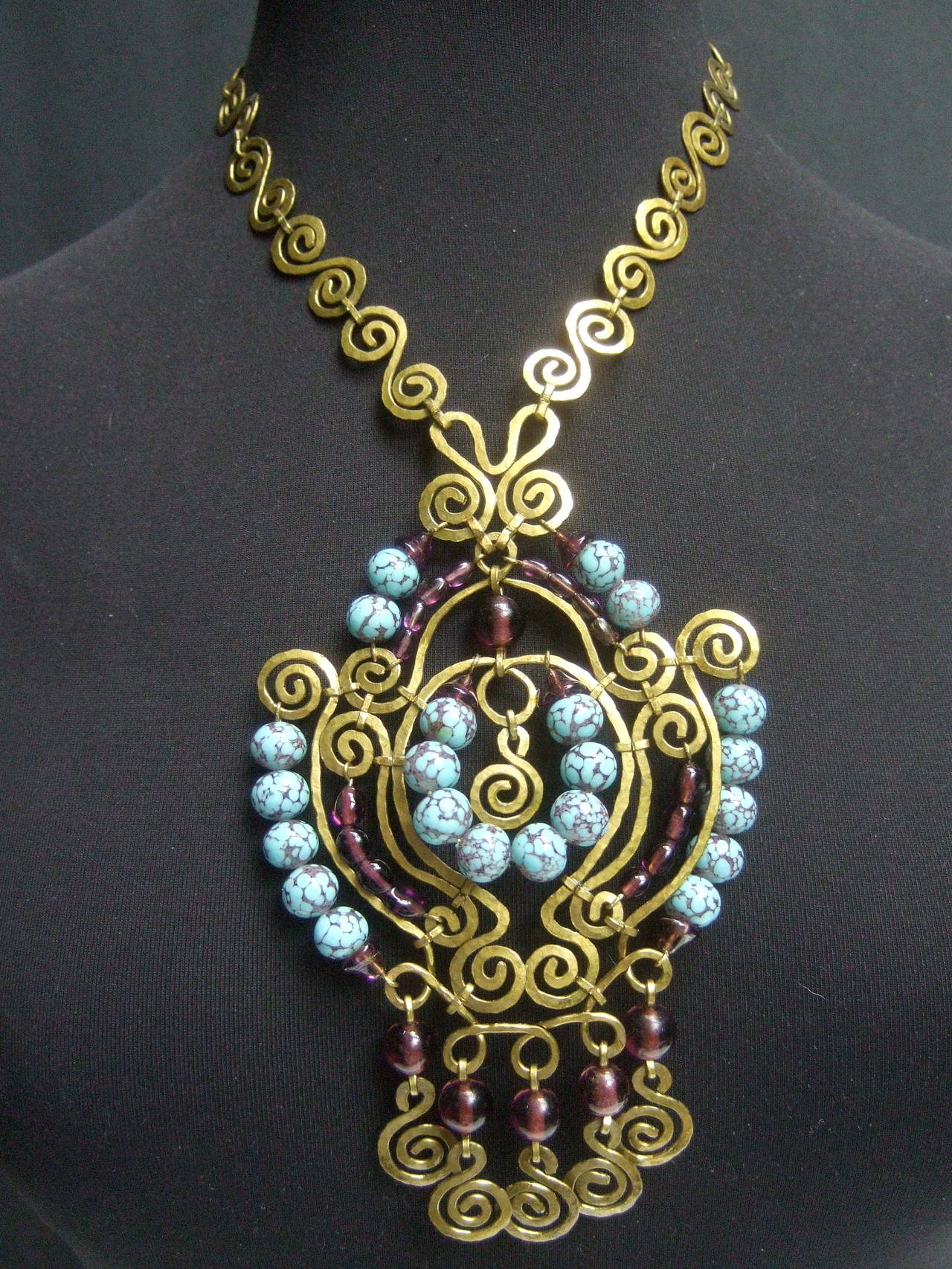 Exotic massive glass beaded Etruscan style pendant necklace 
The ornate artisan necklace is embellished with a cluster of
amethyst color translucent glass beads juxtaposed with aqua
blue opaque glass beads

The glass beads are wired onto a