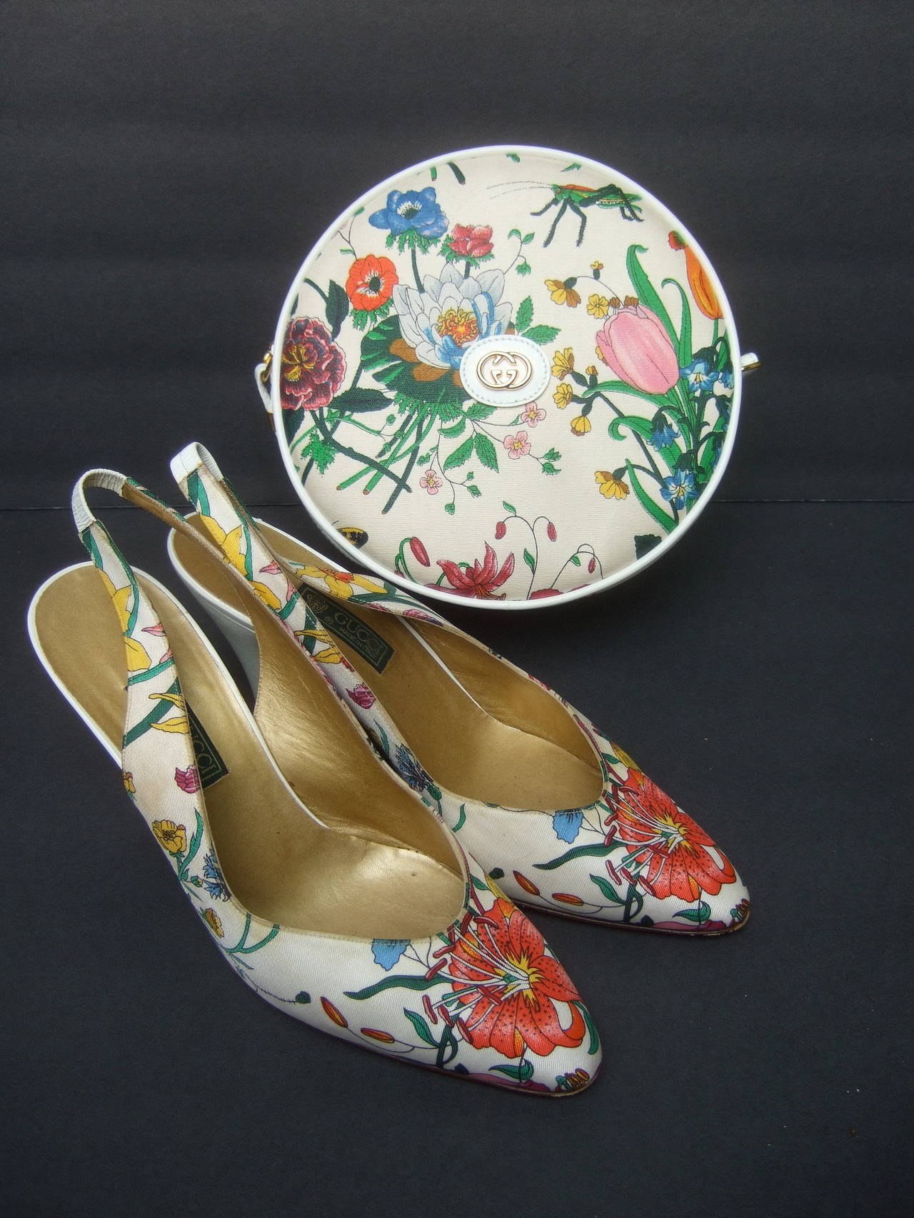 Gucci Chic 'flora' print handbag & matching silk sling back pumps c 1970s
The stylish Gucci round canteen shoulder bag is designed
with canvass flower print fabric; illustrated with vibrant flower
blooms with a grasshopper on both the front &