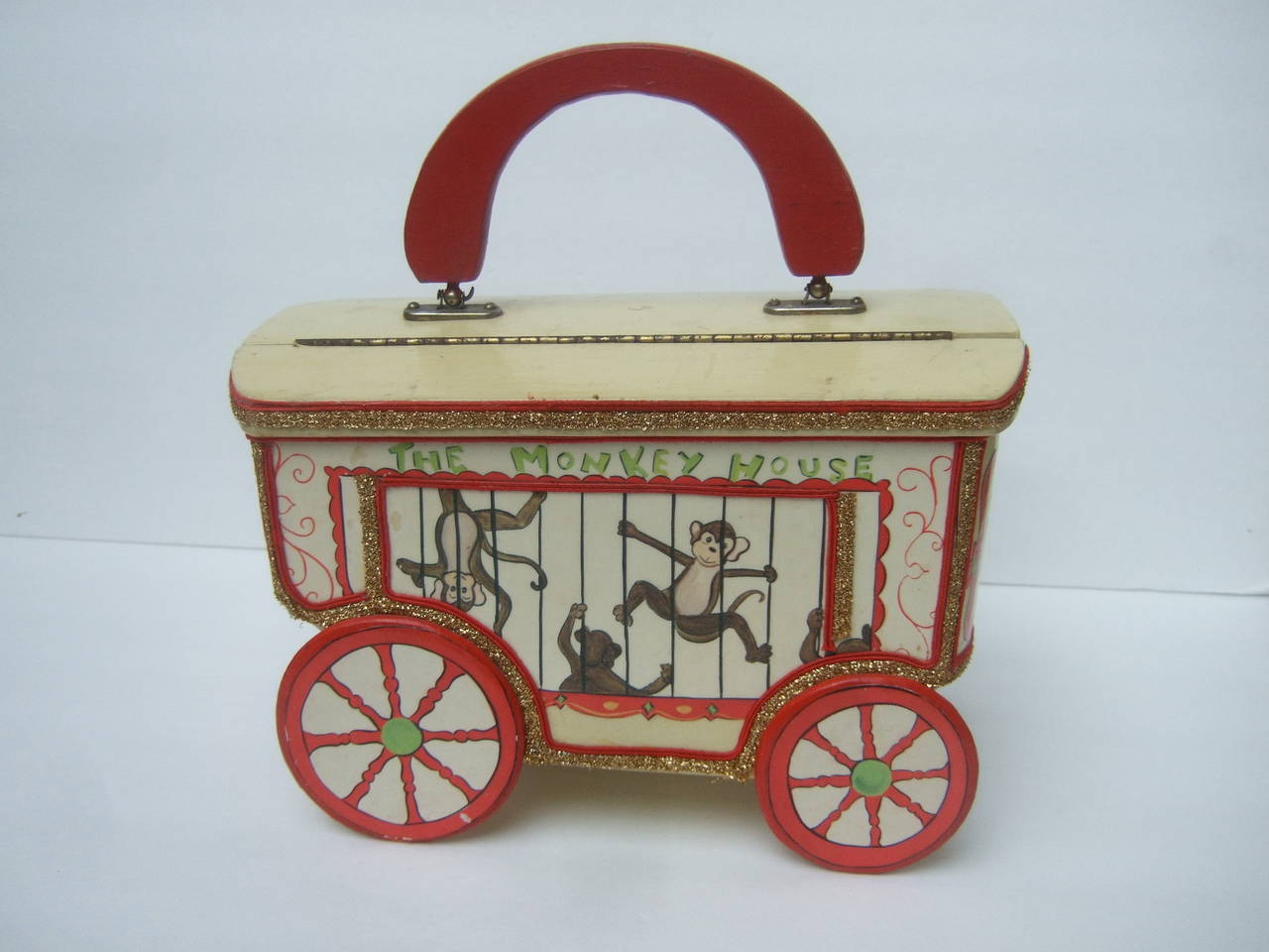 Whimsical monkey circus theme decoupage handbag c 1970
The quirky retro wood handbag is designed with a 
collection of charming decoupage monkeys 

The circus theme wood monkey cage handbag
is designed with four stationary wood enamel
spoke