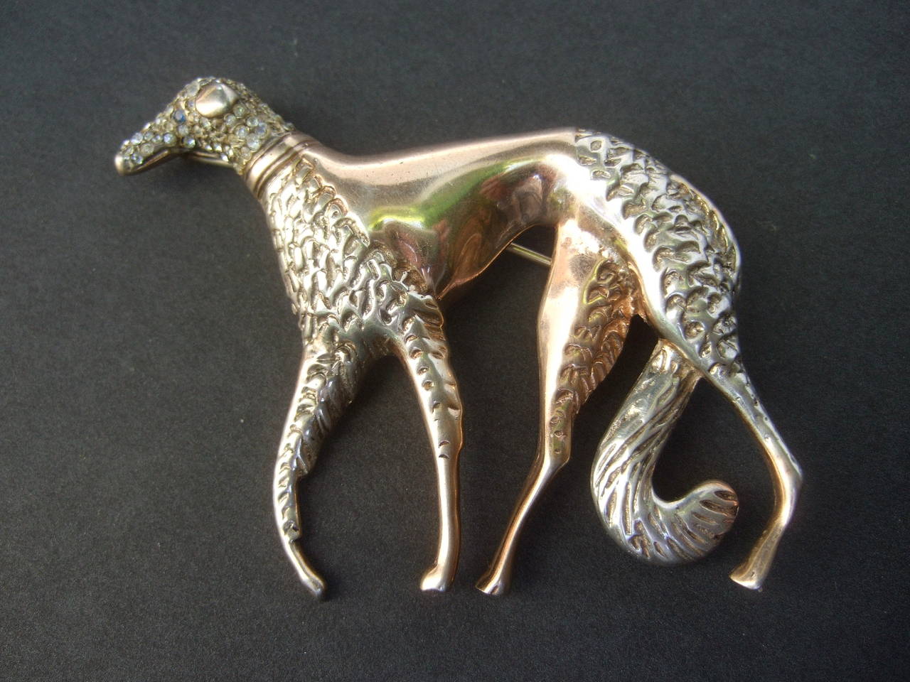 Exquisite Art Deco Borzoi sterling vermeil brooch c 1940s
The elegant stylized canine brooch is encrusted 
with glittering pave crystals on the dog's head
The dog's eye is embellished with a single sapphire  
blue tiny crystal 

The borzoi's