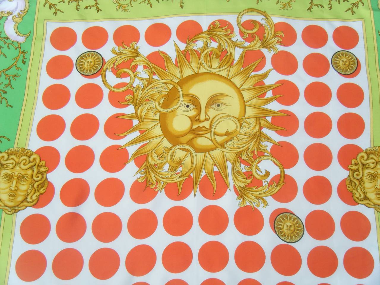 This one is just so perfect for summer!  

Huge 100% silk Versace Couture scarf.

Bold and colorful depiction of a puffing Sun God, Medusas, scrolling vines.

Red, green and yellow color scheme with pale pink frosting in the corner