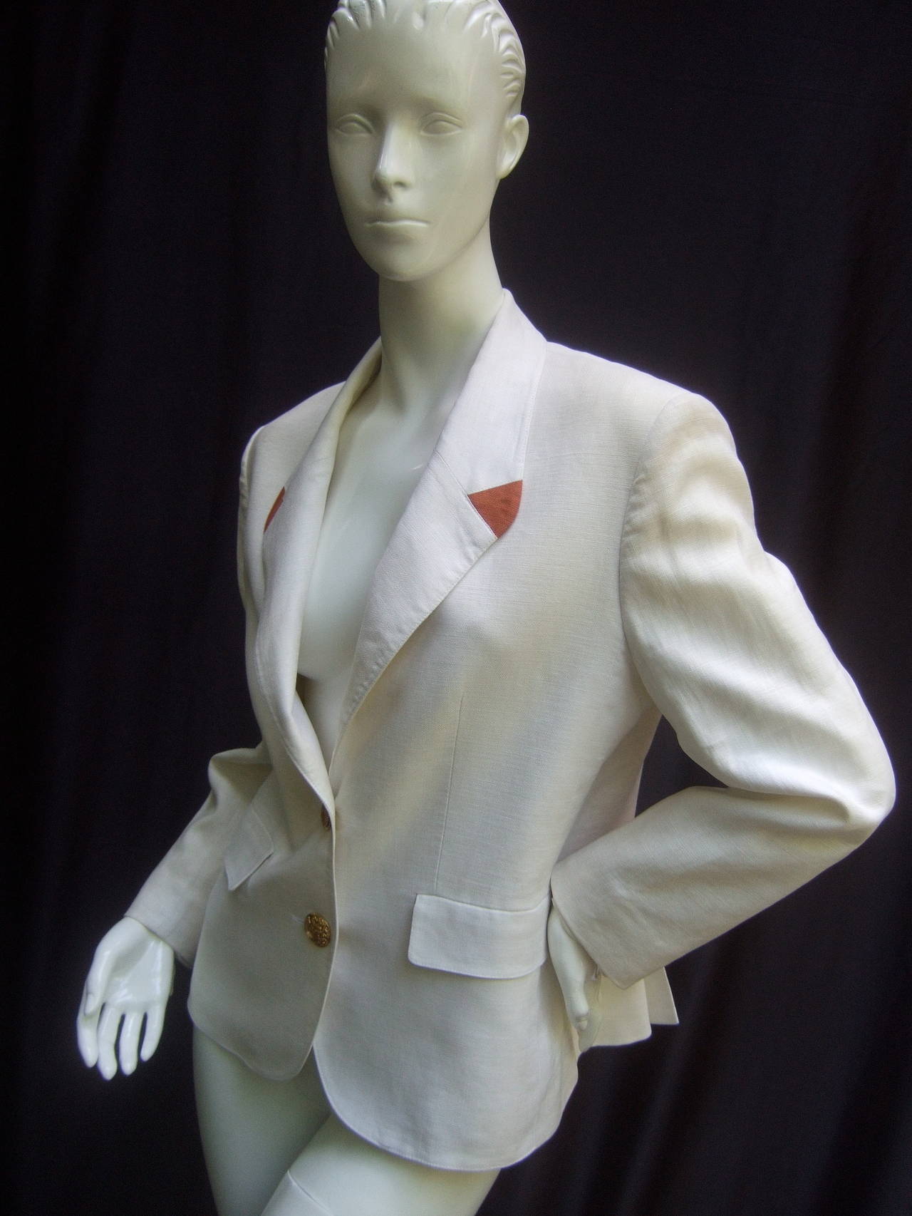 Hermes Paris Crisp white linen jacket Made in France 
The classic high fashion linen jacket is accented
with copper linen triangular panels on the lapels

The chic linen jacket is adorned with two large
gilt metal insignia buttons with Hermes
