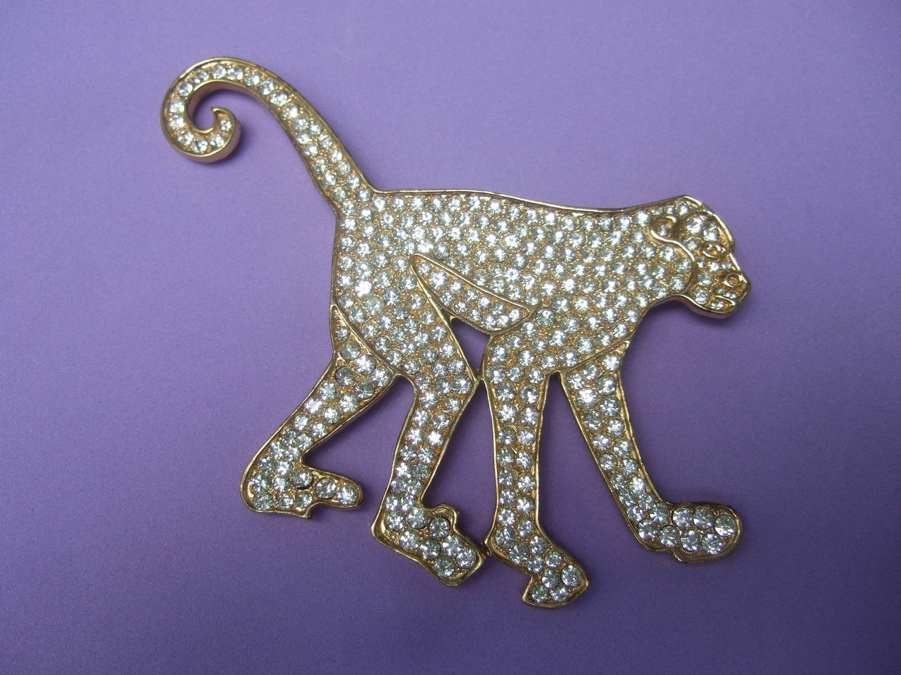 Massive avant-garde figural monkey brooch designed by Robin Kahn
The unique figural brooch is encrusted with glittering 
diamante pave crystals

The huge brooch is designed with gilt metal stamped 
Robin Kahn 

The whimsical monkey brooch