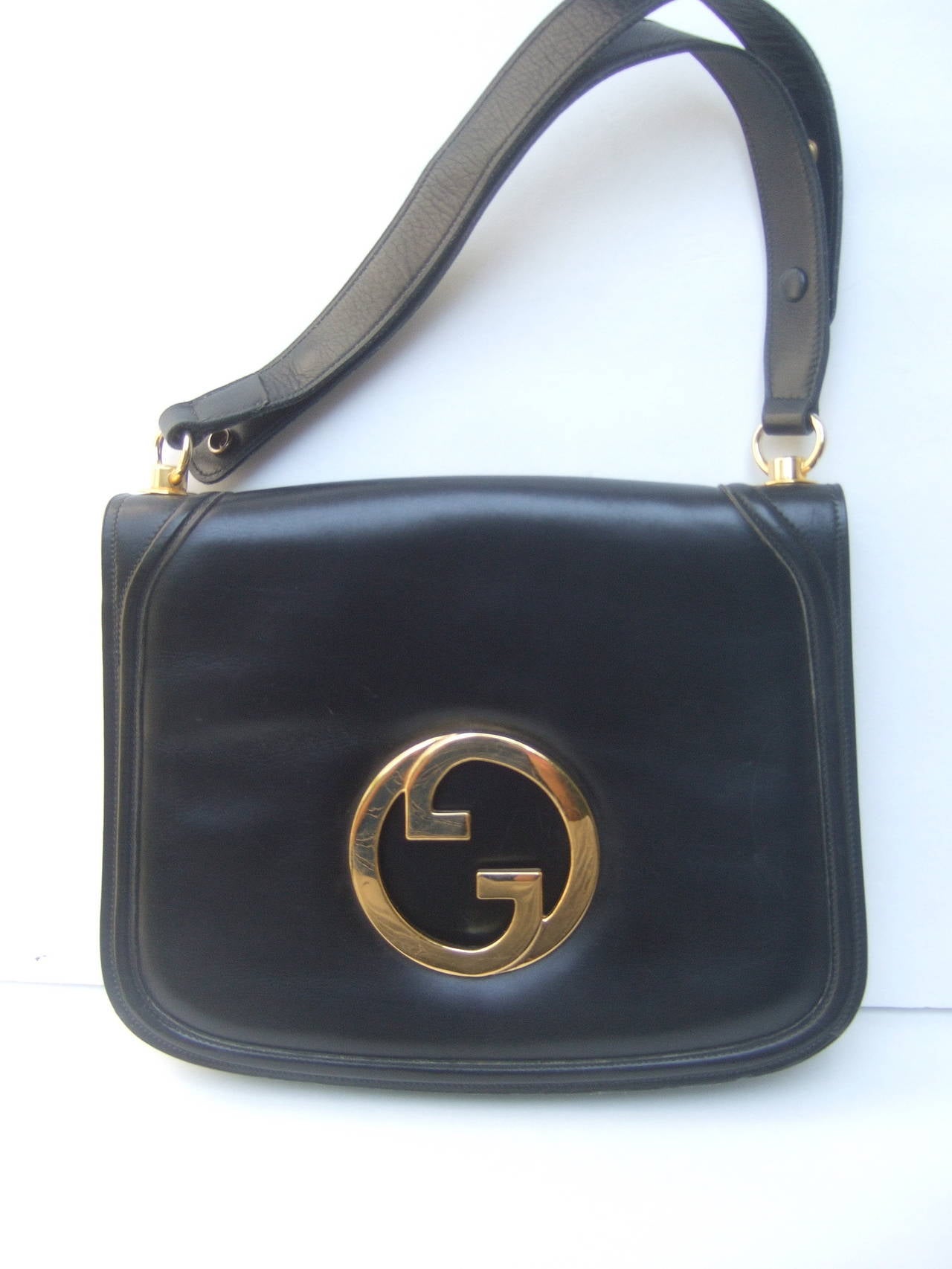 Gucci Sleek ebony leather blondie handbag / shoulder bag c 1970
The iconic Italian Gucci handbag is adorned with Gucci's
massive interlocked gilt metal G.G. initials 

The interior is lined in tan leather with a center 
divided compartment. The