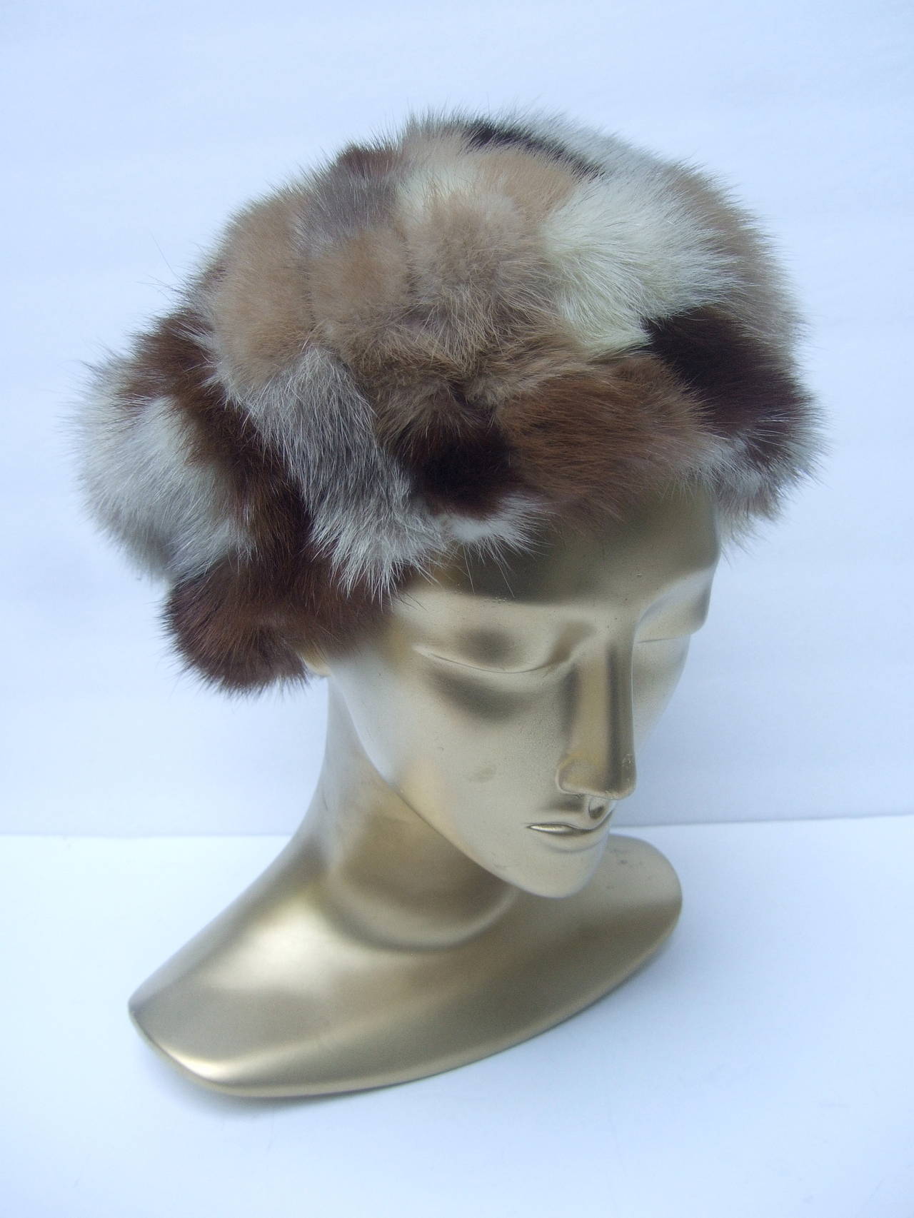 Saks Fifth Avenue Patch tile hat c 1970
The stylish retro mink fur hat is designed 
with a myriad of different colors of mink

The mink patch tiles range from blonde,
to medium brown to darker mahogany 

The interior is lined in brown