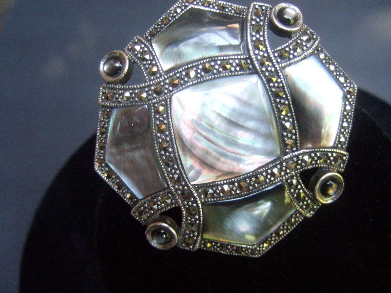 Exquisite mother of pearl sterling marcasite brooch 
The elegant large scale brooch is embellished 
with inlaid tiles of lustrous mother of pearl

The mother of pearl tiles are framed with sinuous 
bands of glittering marcasite crystals. The