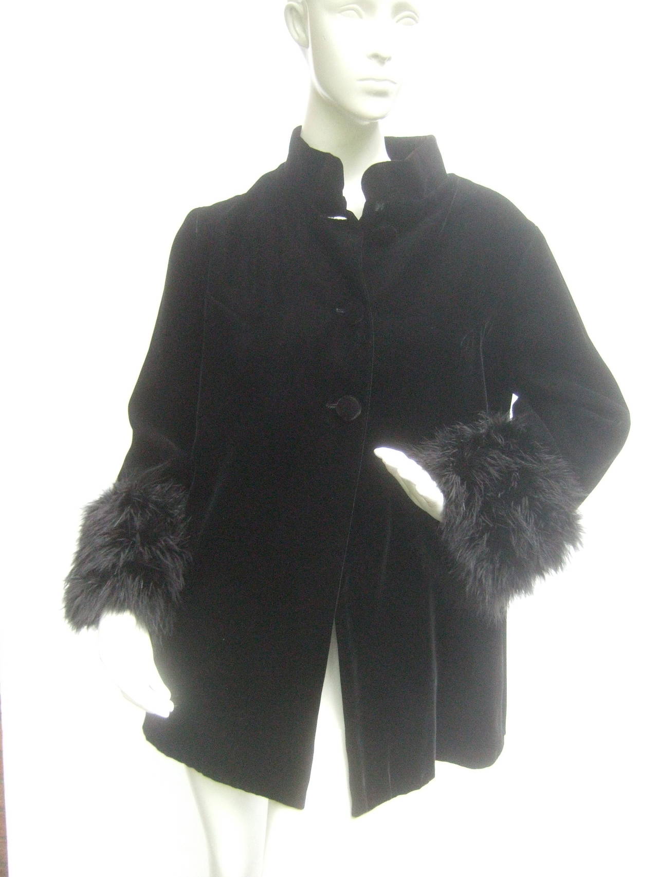Black velvet marabou cuff mandrian collar jacket c 1970s 
The stylish cotton velvet jacket is embellished
with wide black fluffy marabou feather cuffs

The jacket secures with three matching black
velvet buttons on the bodice. The velvet