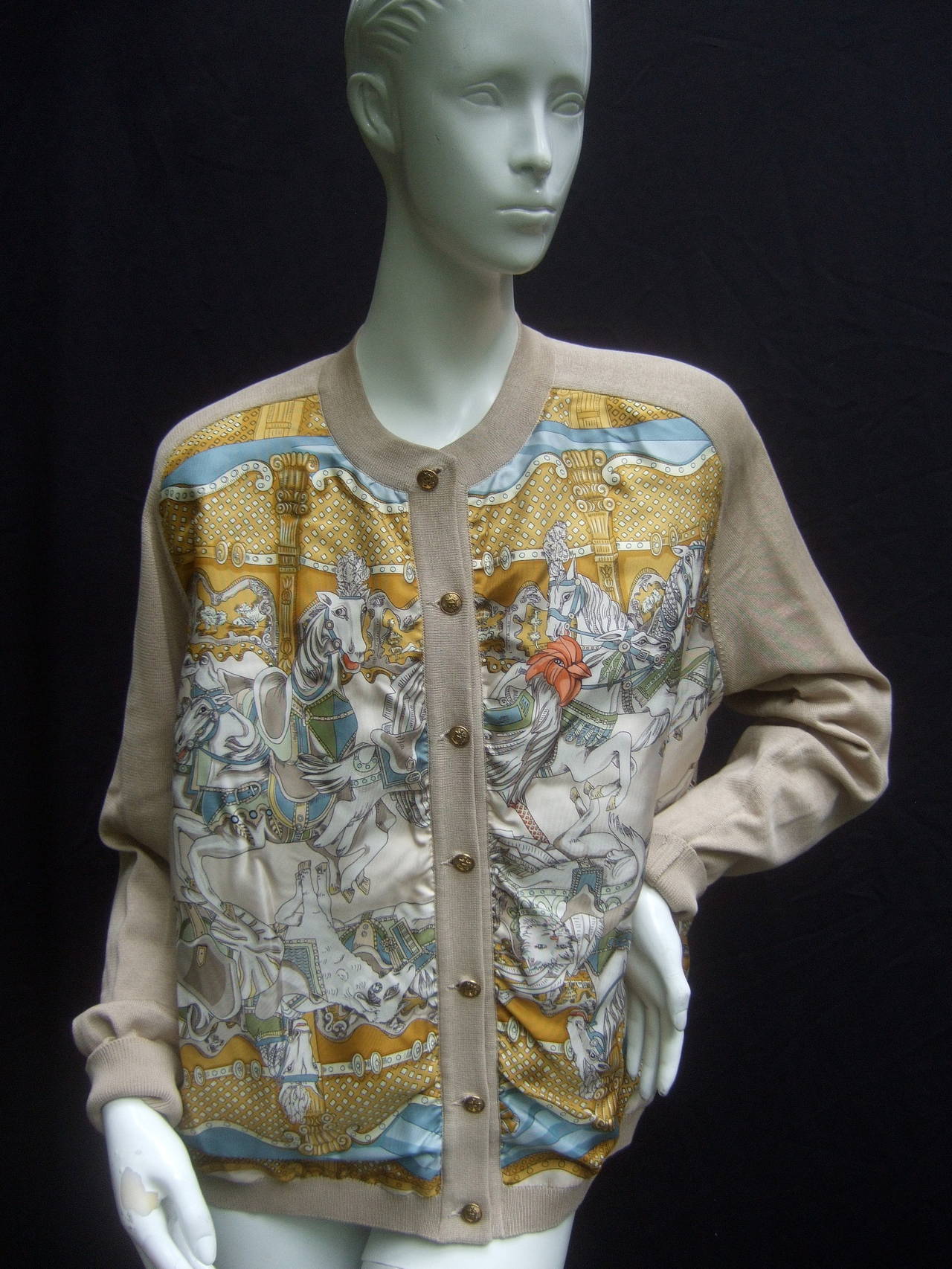 Hermes Paris Luxurious silk panel cardigan Size 46
The elegant cardigan is illustrated with a collage
of animal figures; horses, roosters. canine, feline.
goats and lamb

The front silk panels range from golden yellows,
ivory and cream, pale
