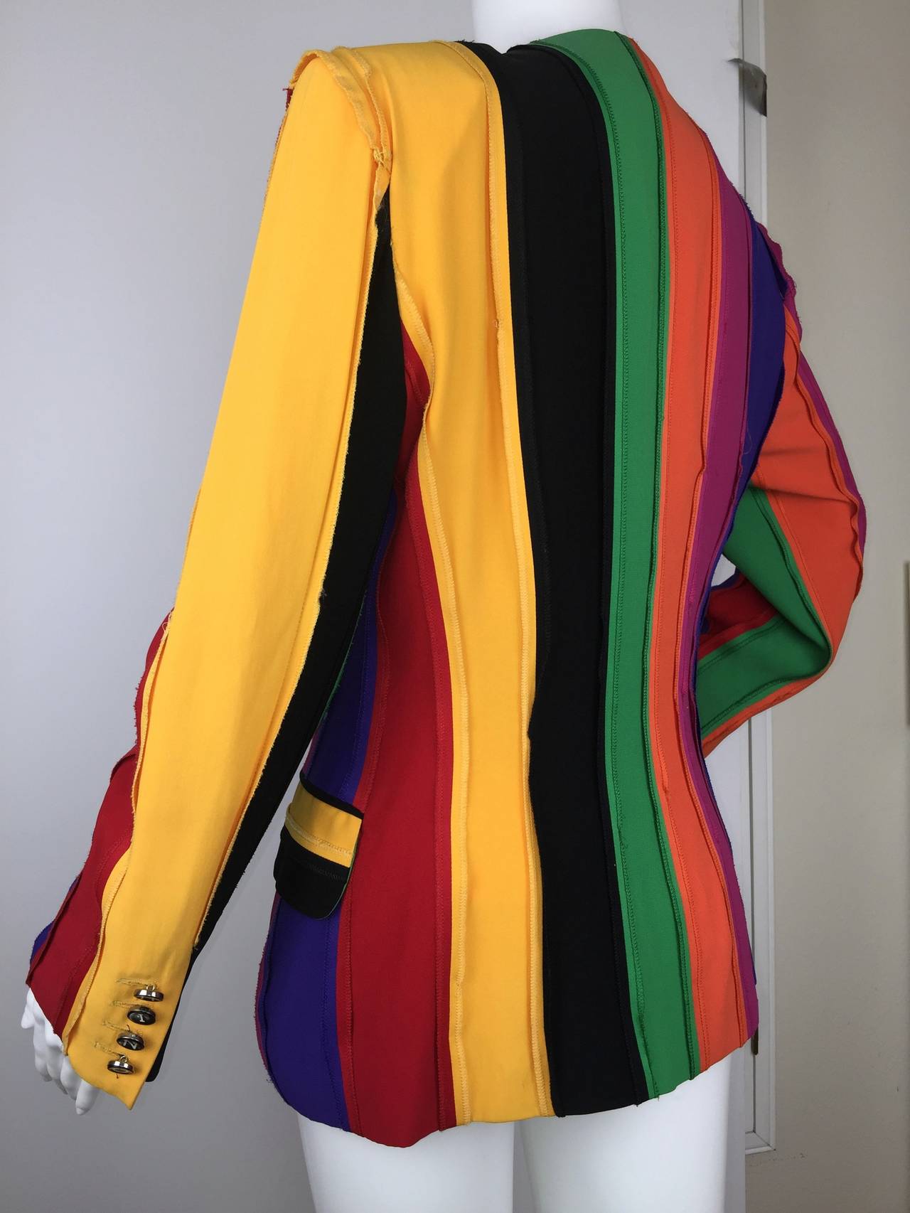 Vintage rainbow color block jacket designed by Franco Moschino. 

The playfulness and wit of his iconic 90's designs are fully on display here.  

Retro typewriter keys spell out the brand both down the front and when combined on both sleeves.