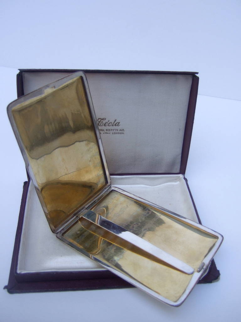 SAKS FIFTH AVENUE Sterling & 14k gold cigarette case c 1950
The opulent art deco cigarette case is designed in sterling
with bands of rose, white & yellow 14k gold

The center of the case is designed with a rectangular plaque
for an inscription