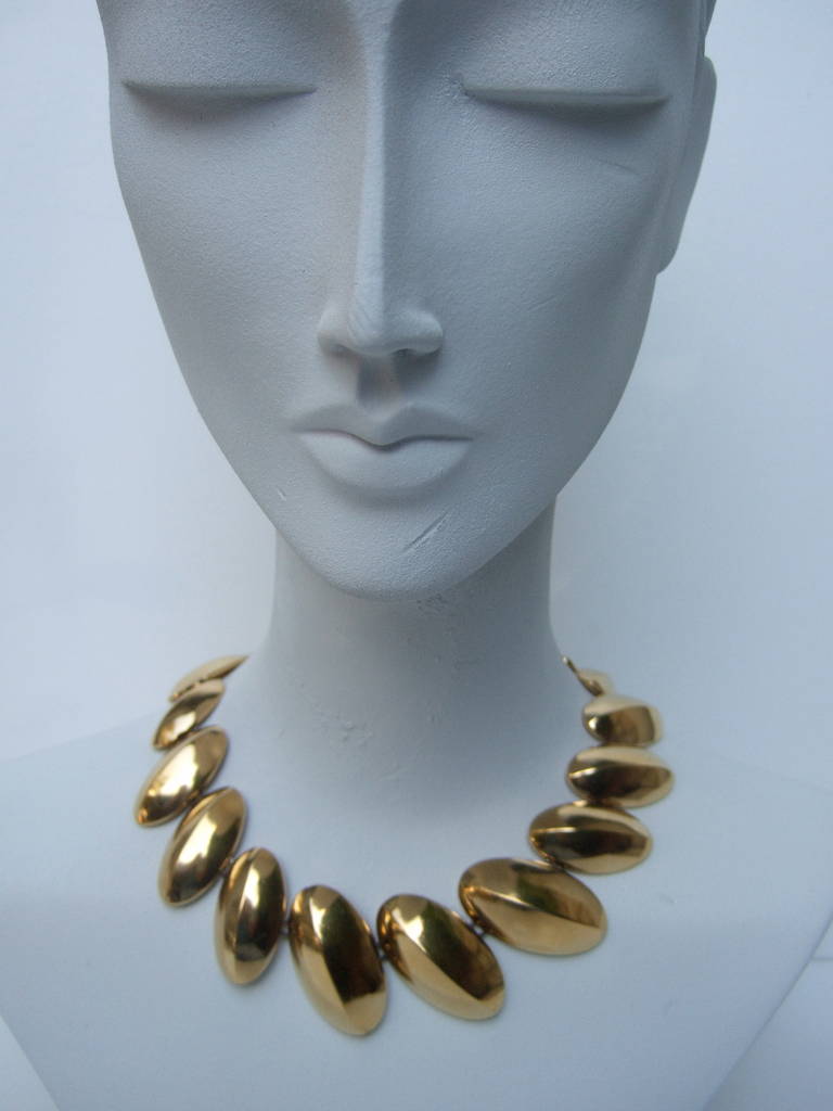 Yves Saint Laurent Gilt disc necklace c 1980
The sleek gilt metal necklace is designed
with a series of graduated oval links