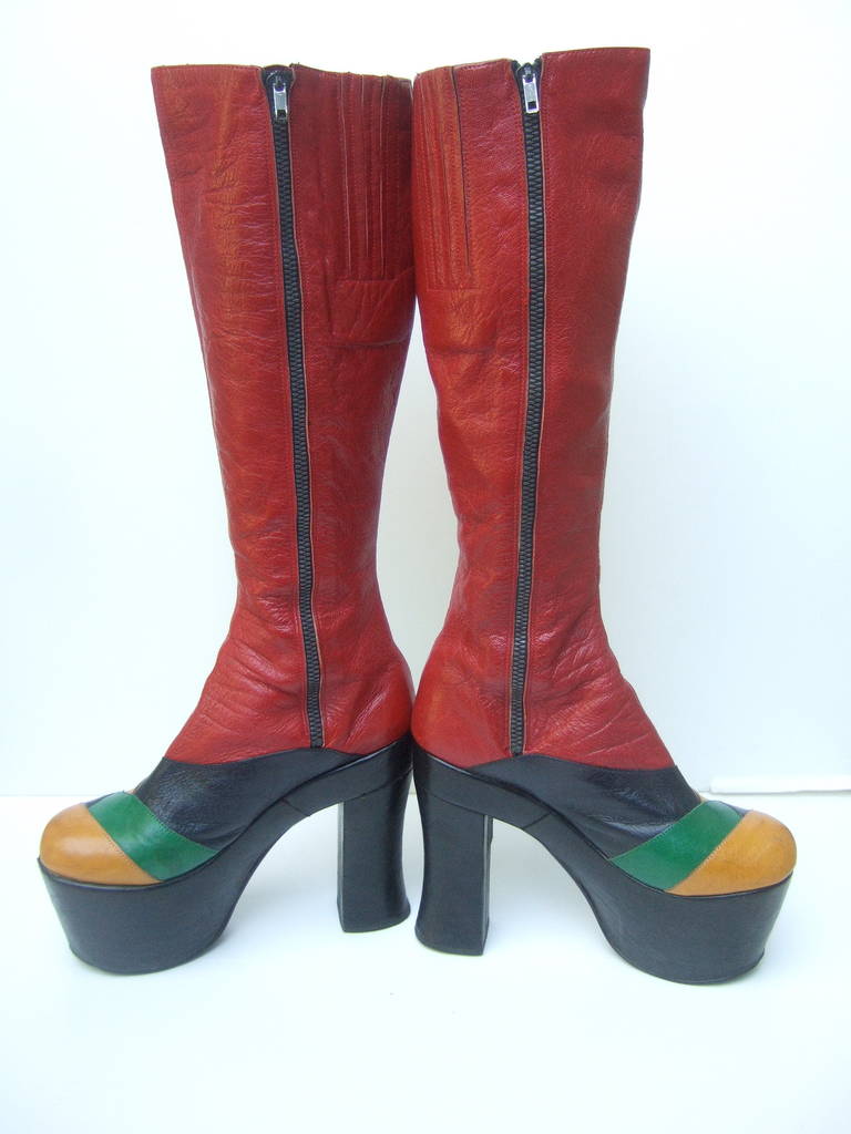 1970s Incredible glam rock leather platform boots Made in Italy 
Amazing dramatic leather boots designed with red, yellow, black
& green panels. The fantastic design epitomizes the high fashion 
Studio 54 styles. The extraordinary design is