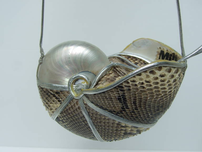 Exotic python chamber nautilus evening bag c 1970
The extraordinary avant-garde purse is designed 
by Mille Fiori. The organic shell is covered partially
with python skin with the lustrous shell exposed
at the top

The chamber nautilus shell