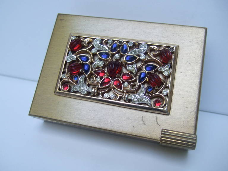 Trifari Opulent Art Deco "Jewels of India" compact c 1950
The exquisite designer compact is encrusted with 
ruby glass & crystal sapphire glass settings
The ornate design is embellished with glittering 
diamante crystals set in the