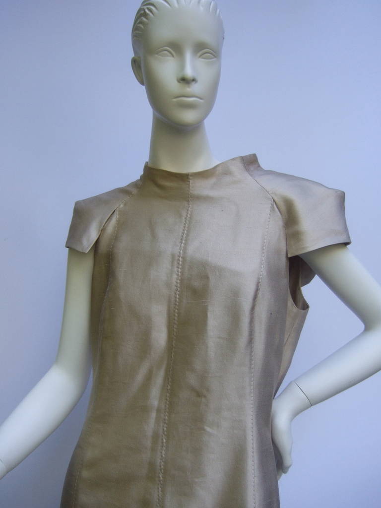 Gianfranco Ferre Elegant champagne silk sheath dress Made in Italy Size 46
The stylish dress is designed with luminous champagne color silk
The dress has slit cap sleeves with a folded panel on the back side

The front silhouette is designed with