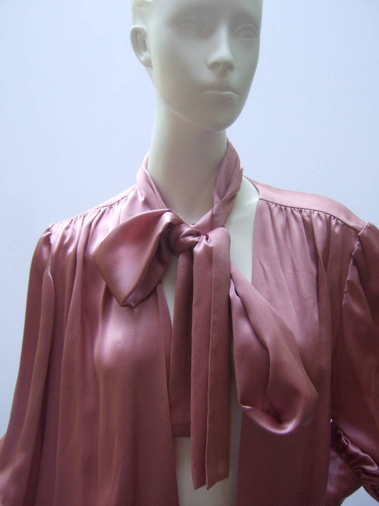Saint Laurent Rive Gauche Mauve silk charmeuse blouse Size 40 c 1970s
The elegant blouse is designed with luxurious voluminous silk
The blouse has a matching versatile scarf that may be worn 
in a billowy pussy cat bow or wrapped around the neck