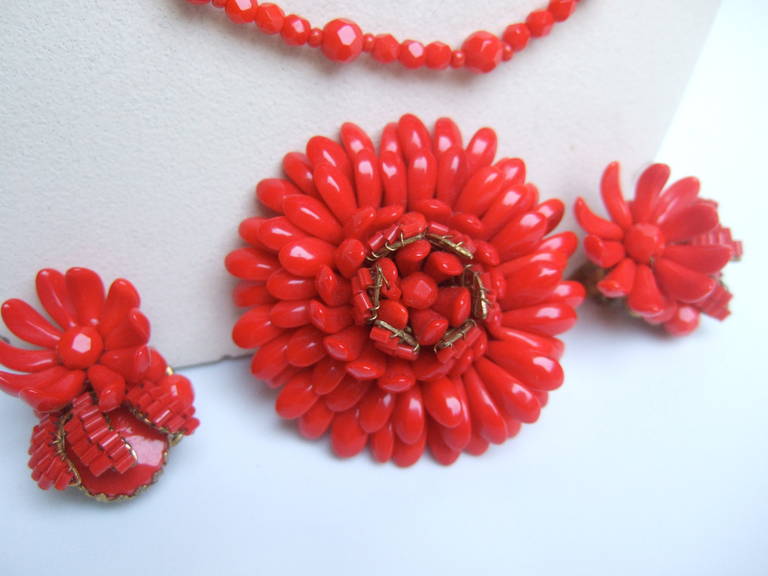 MIRIAM HASKELL Scarlet glass beaded necklace set c 1960
The unique necklace set is designed with clusters 
of red glass beads that emulate flowers pedals

The necklace consist of five graduated rows of faceted
glass beads intermixed with larger
