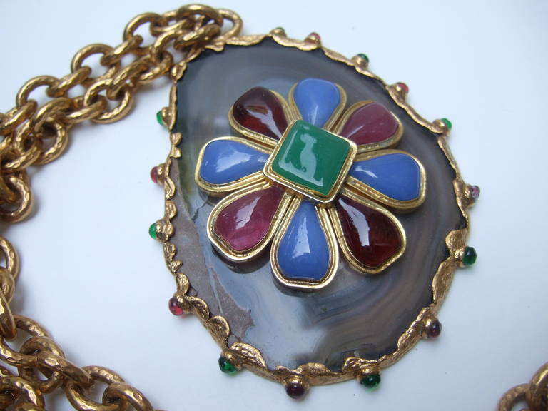 CHANEL Incredible poured glass agate pendent necklace c 1980
The amazing runway design is comprised of faux glass rubies.
glass color sapphires, & emerald green poured glass stones.

The avant-garde design is set on a slice of agate. The