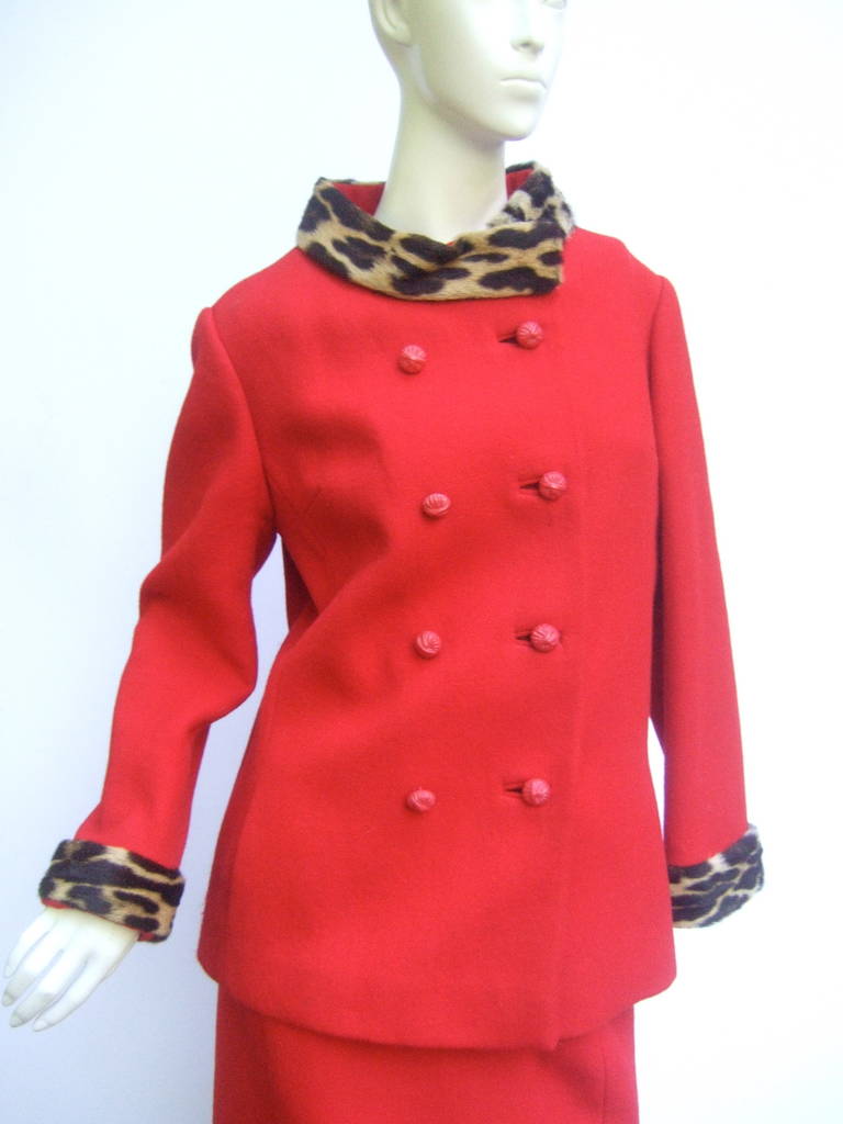 1960s Leopard trim red wool skirt suit 
The stylish high fashion suit is adorned
with a genuine leopard fur collar & cuffs

The double breasted jacket is designed 
with red 8 resin buttons. The jacket & skirt
are lined in red. The suit