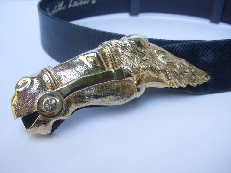 JUDITH LEIBER Gilt metal equine buckle blue leather belt c 1980
The equestrian style belt is adorned with a stylized gold metal
horse head buckle. The belt is designed with dark blue leather
with an embossed finish that emulates reptile