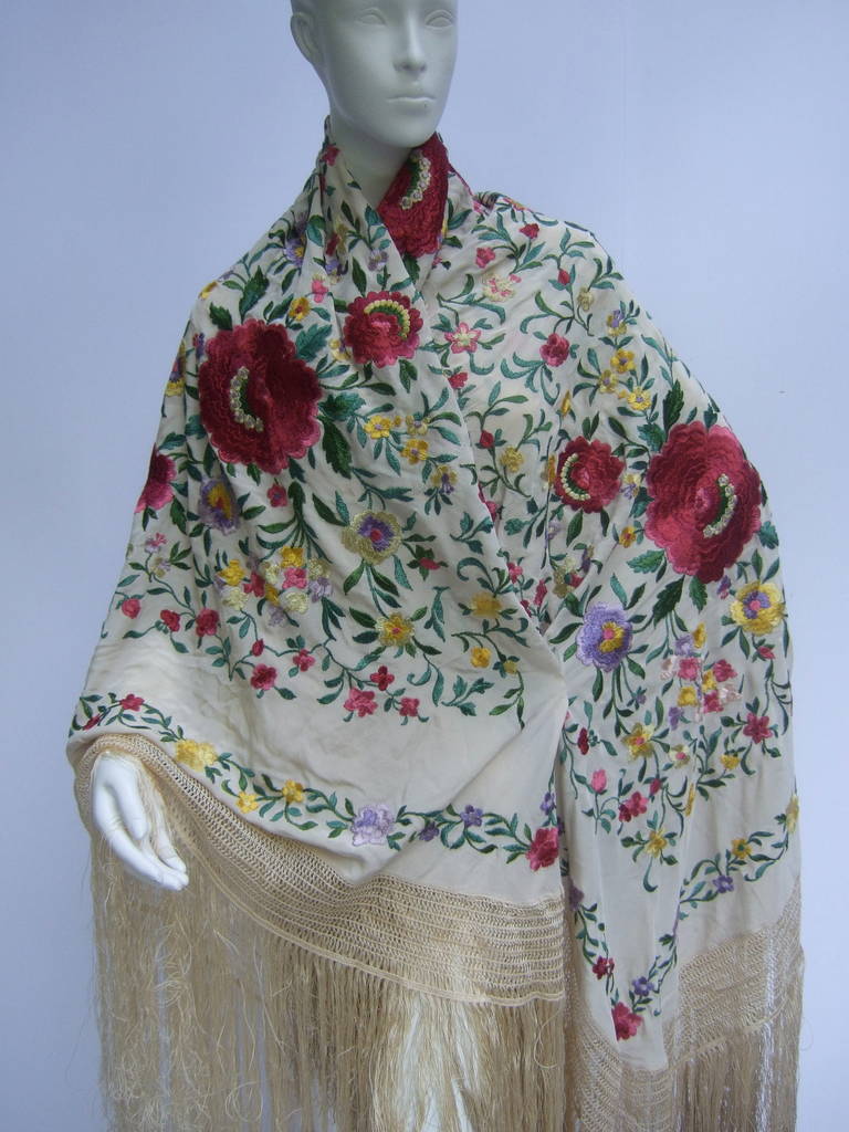 1920s Exotic silk floral embroidered piano shawl
The exquisite hand embroidered shawl is a profusion 
of lush flower blooms set against an ivory silk background

The collage of intricate flowers are a vibrant field of lavender,
golden yellow,