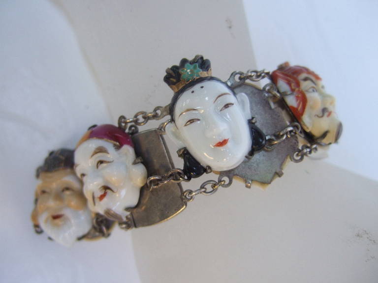Seven lucky gods of Japan silver bracelet ca 1950s
The seven gods of good fortune in Japanese mythology & folklore 
They are often the subject of Netsuke carvings & other representations 

The intricate hand painted faces are designed with