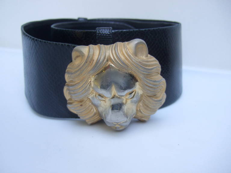 Judith Leiber Ornate lion buckle black embossed leather belt c 1980
The elegant belt is adorned with a large stylized lion head buckle
The lion's face is designed with smooth silvery / gilt metal finish
The lion's face has some plating wear