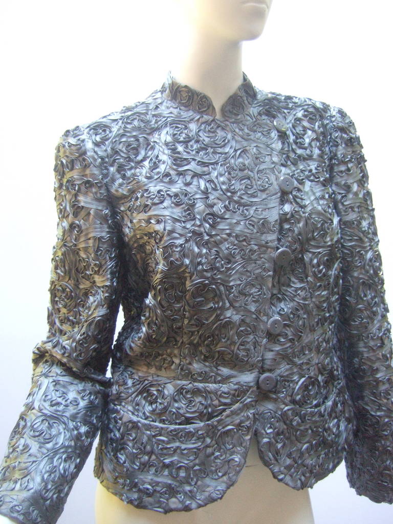 Armani Stunning pewter satin evening jacket US Size 8 
The elegant high fashion jacket is embellished with sinuous  gray ribbons
throughout the textured fabric. The gun metal gray ribbon has a luminous 
sheen. The jacket is designed with a
