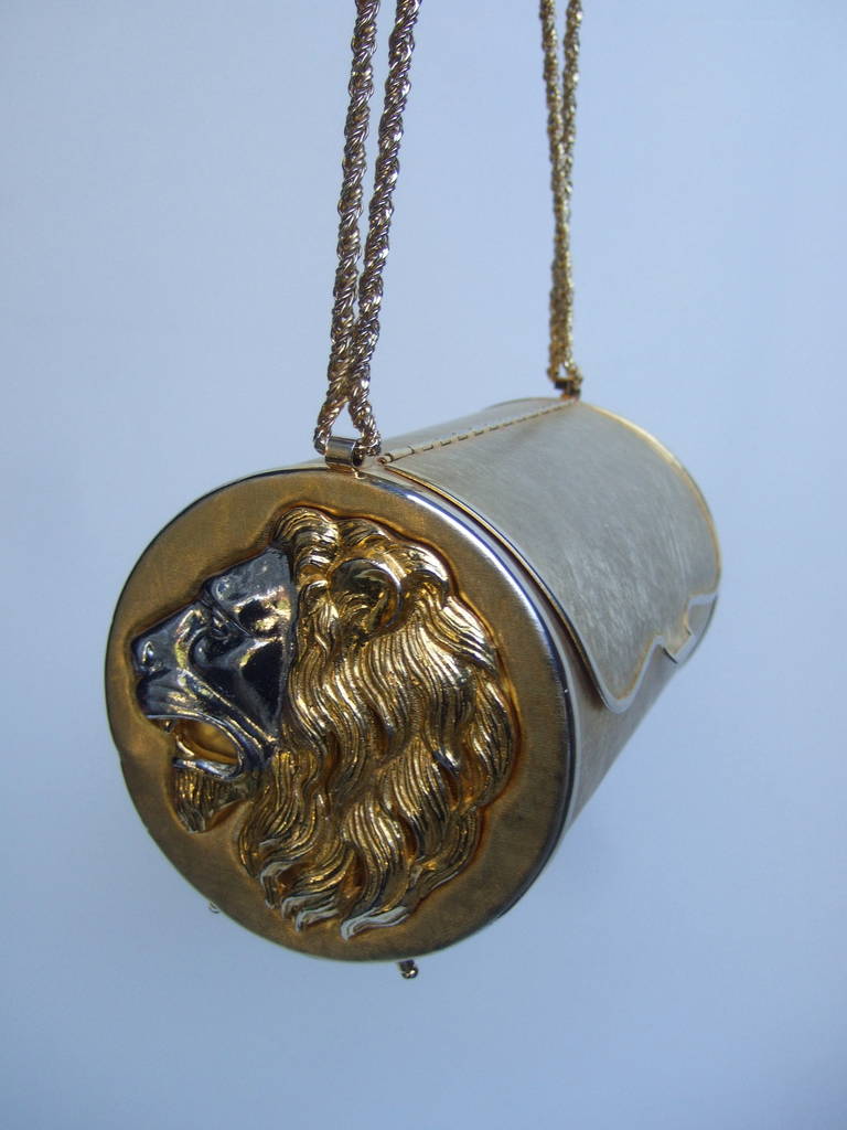 HARRY ROSENFELD Opulent gilt metal lion evening bag Made in Italy 
The lavish gold metal cylinder evening bag is adorned with a pair of ornate lion emblems on each exterior side

The stylized lions are designed with intricate silver metal faces