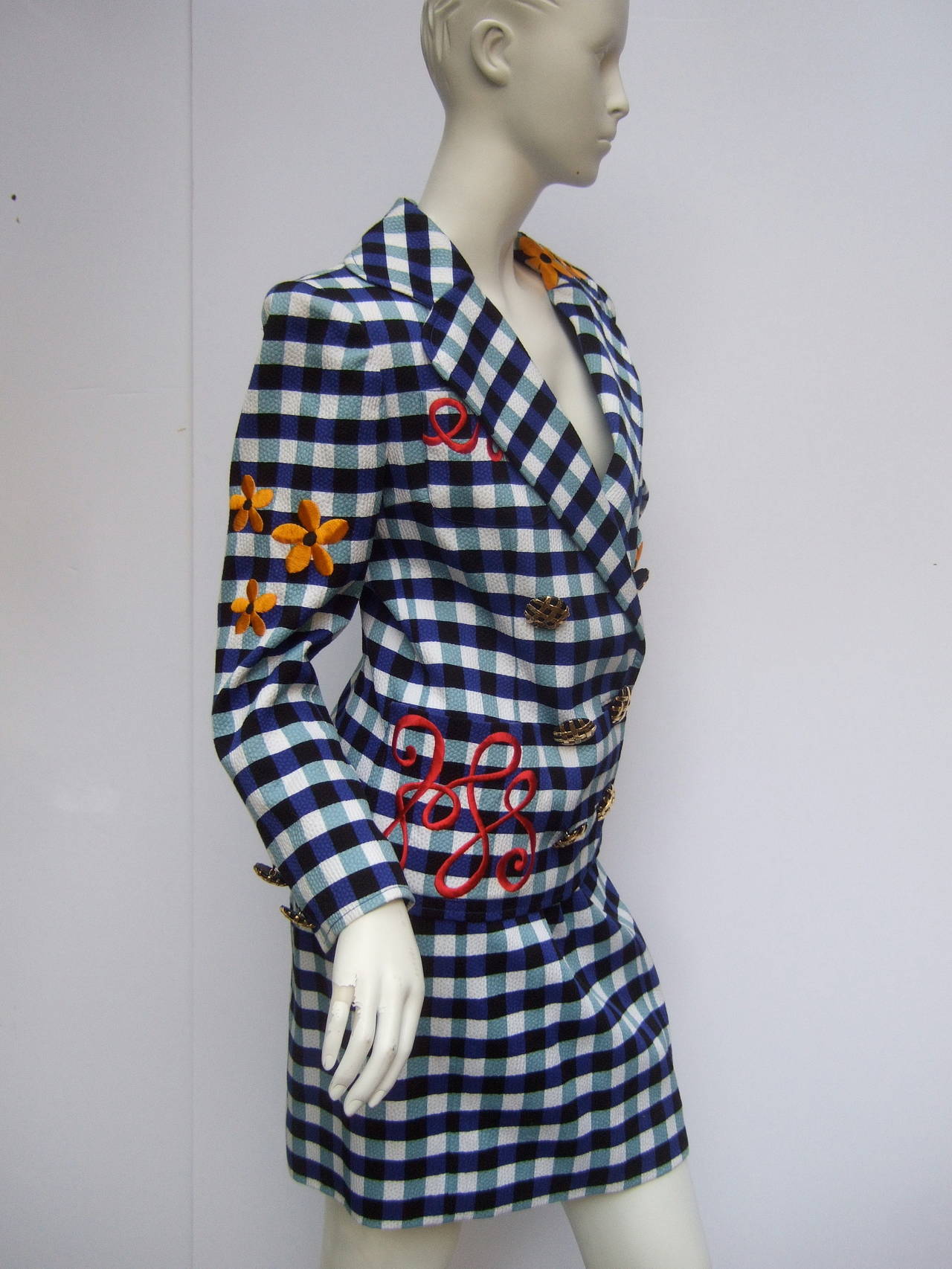 Christian Lacroix Paris Stunning flamboyant skirt suit Size 36
The show stopping suit is designed with a bold checkerboard print with embroidered flowers. The checked print is a combination of pale & cobalt blue The back side of the cotton