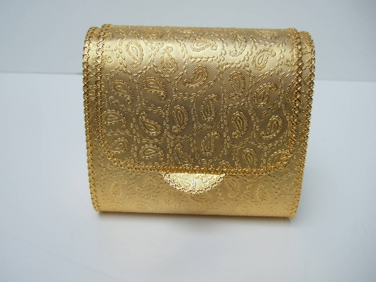 Saks Fifth Avenue Gilt metal evening bag Made in Italy c 1970
The elegant evening bag is covered with paisley designs on the exterior metal
The ornate evening bag is carried with a silver & gilt metal chain strap interspersed with small pastel