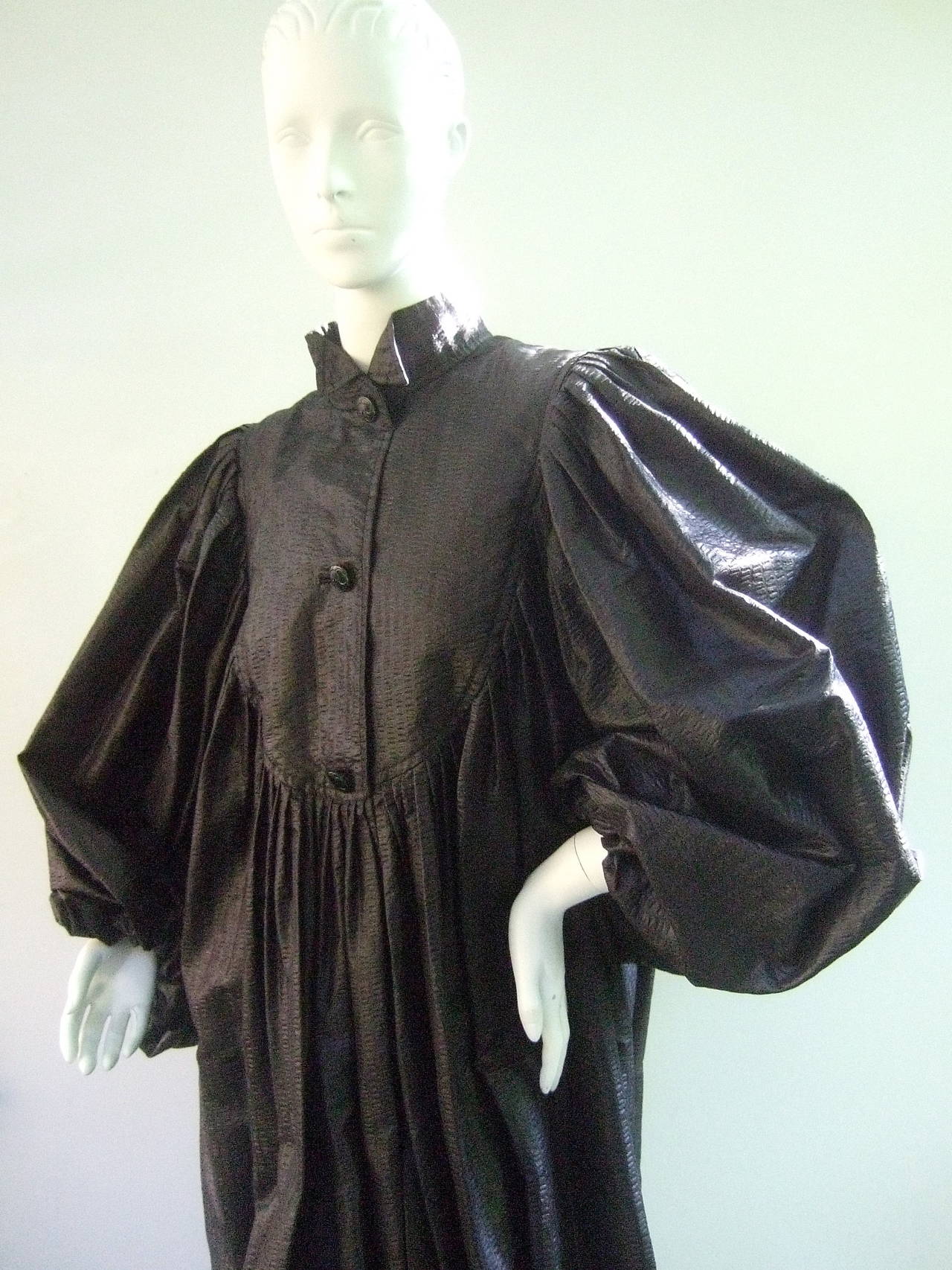 Galanos Avant-garde black voluminous light weight evening coat c 1970
The unique high fashion coat is designed with light weight sheer fabric that resembles tissue paper. The silhouette is enhanced with voluminous billowy poet style sleeves. The