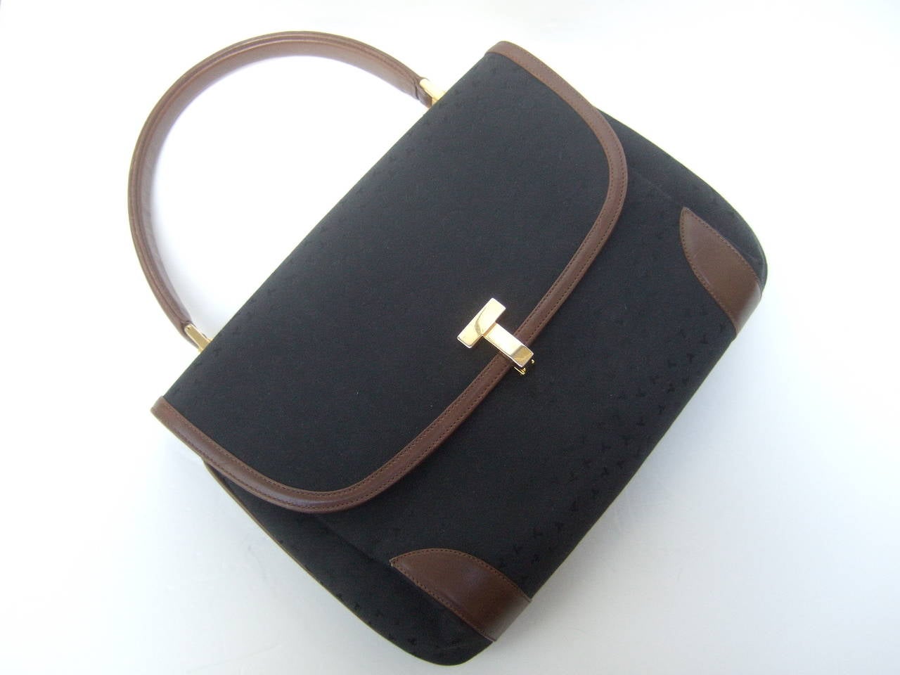 Tiffany & Company Black canvas leather trim handbag Made in Italy c 1980s
The stylish handbag is covered with black canvas with Tiffany's subtle initials repeated throughout the fabric covering 

The handle & sides of the Italian handbag are