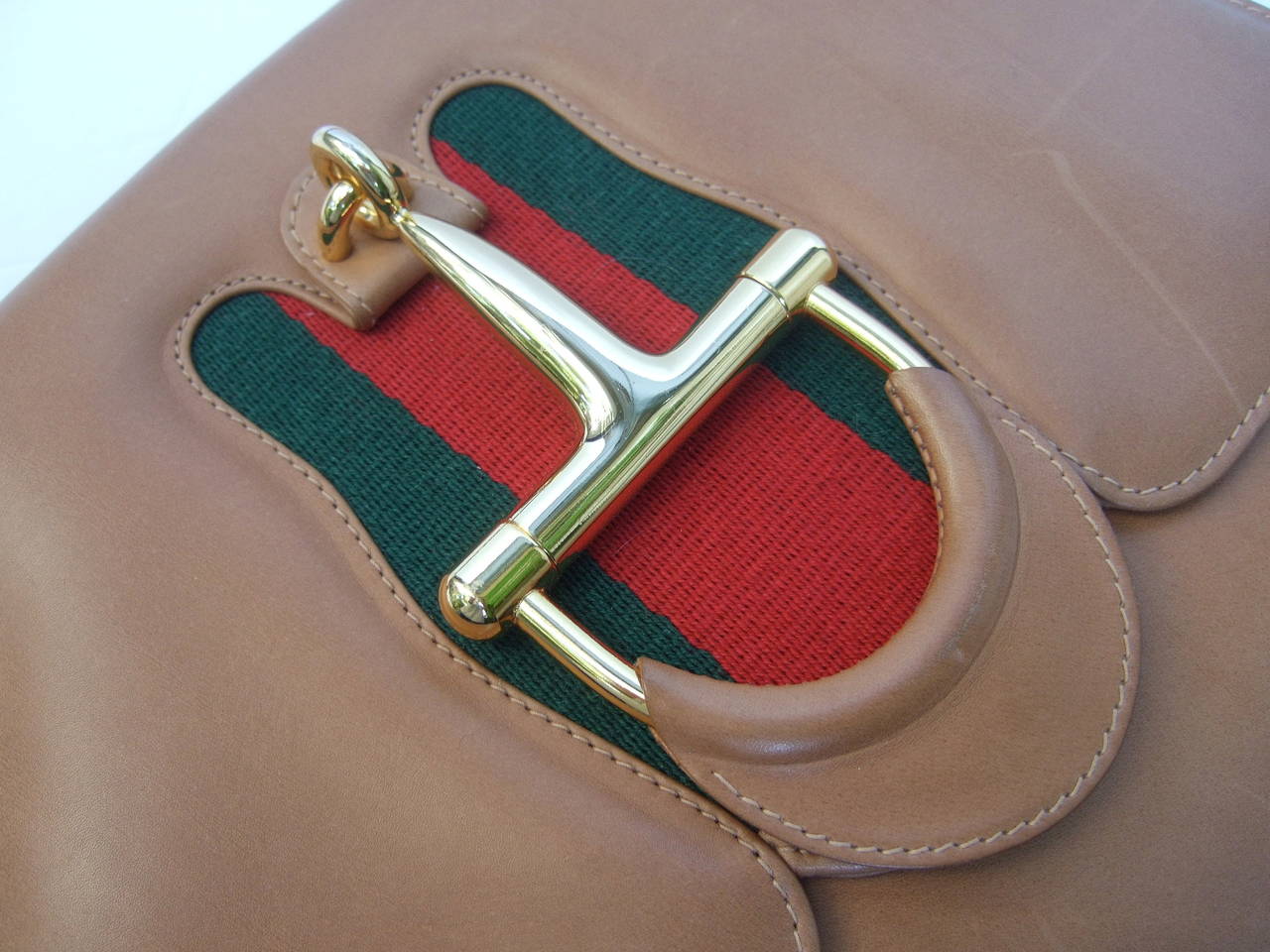 GUCCI Italy Caramel brown leather horse bit clasp shoulder bag c 1970s
The rare Gucci handbag is covered with supple light brown leather
The sleek gilt metal clasp is designed in the style of an equestrian 
bridal bit with Gucci's signature red &