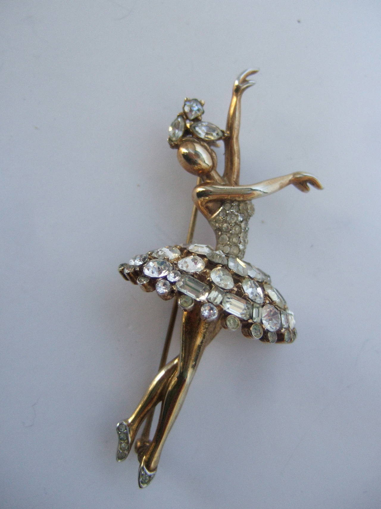 Trifari figural crystal jewel encrusted ballerina brooch c 1950
The mid-century designer costume brooch captures an elegant ballerina in various pirouette postures

Her headpiece, bodice, tutu & slippers are embellished with glittering diamante