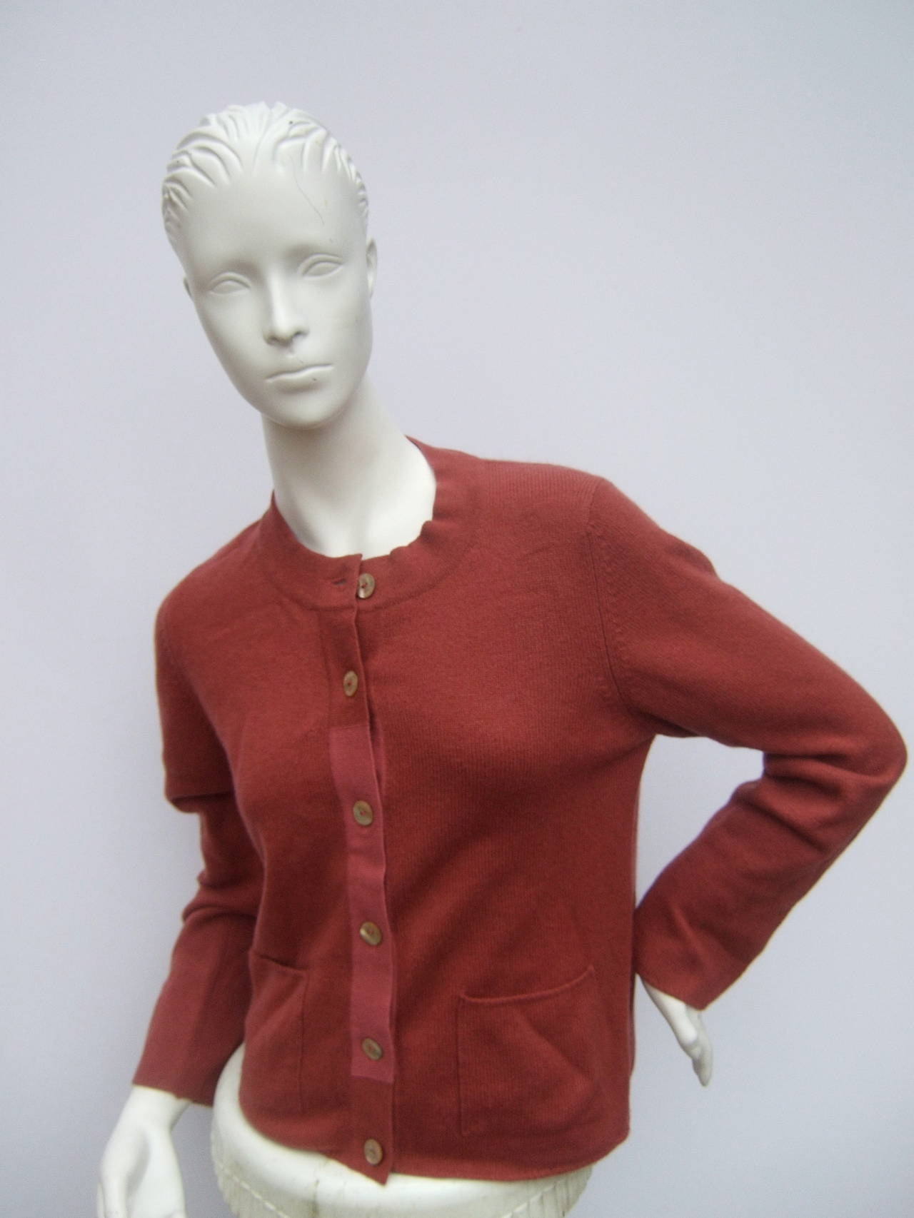 ***RESERVED SALE PENDING FOR ALEXIS ASCHER***
 
Chanel Cashmere berry cardigan with Chanel mother of pearl buttons
The cashmere cardigan is berry color with a section in the center that is mauve blush pink. Designed with six mother of pearl