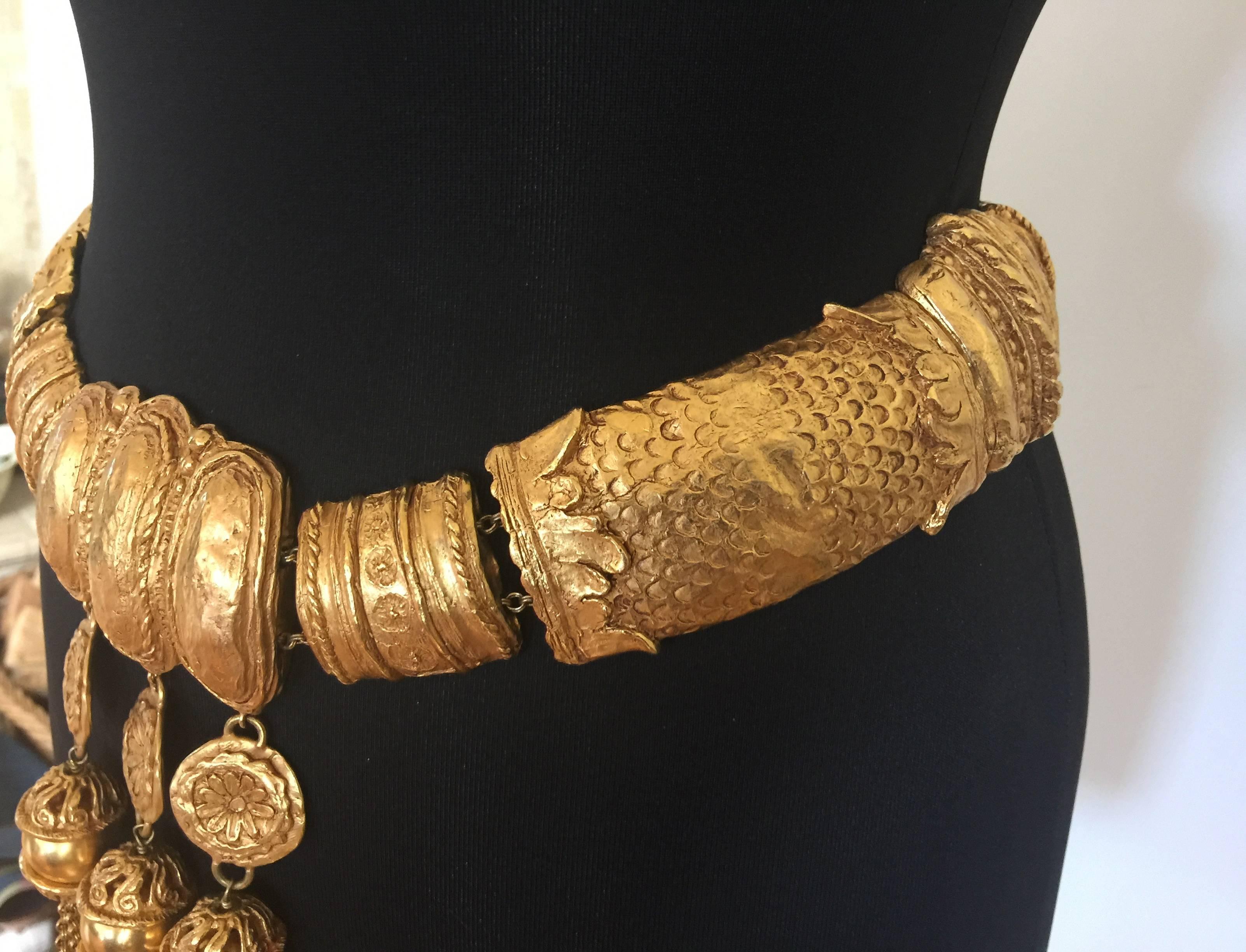 
This Lacroix Haute Couture treasure is just monumental! 

It weighs a ton!

Super chunky gilded cast metal panels are strung on chains and run all the way around the belt for maximum impact.

Striking tribal style design with amazingly long