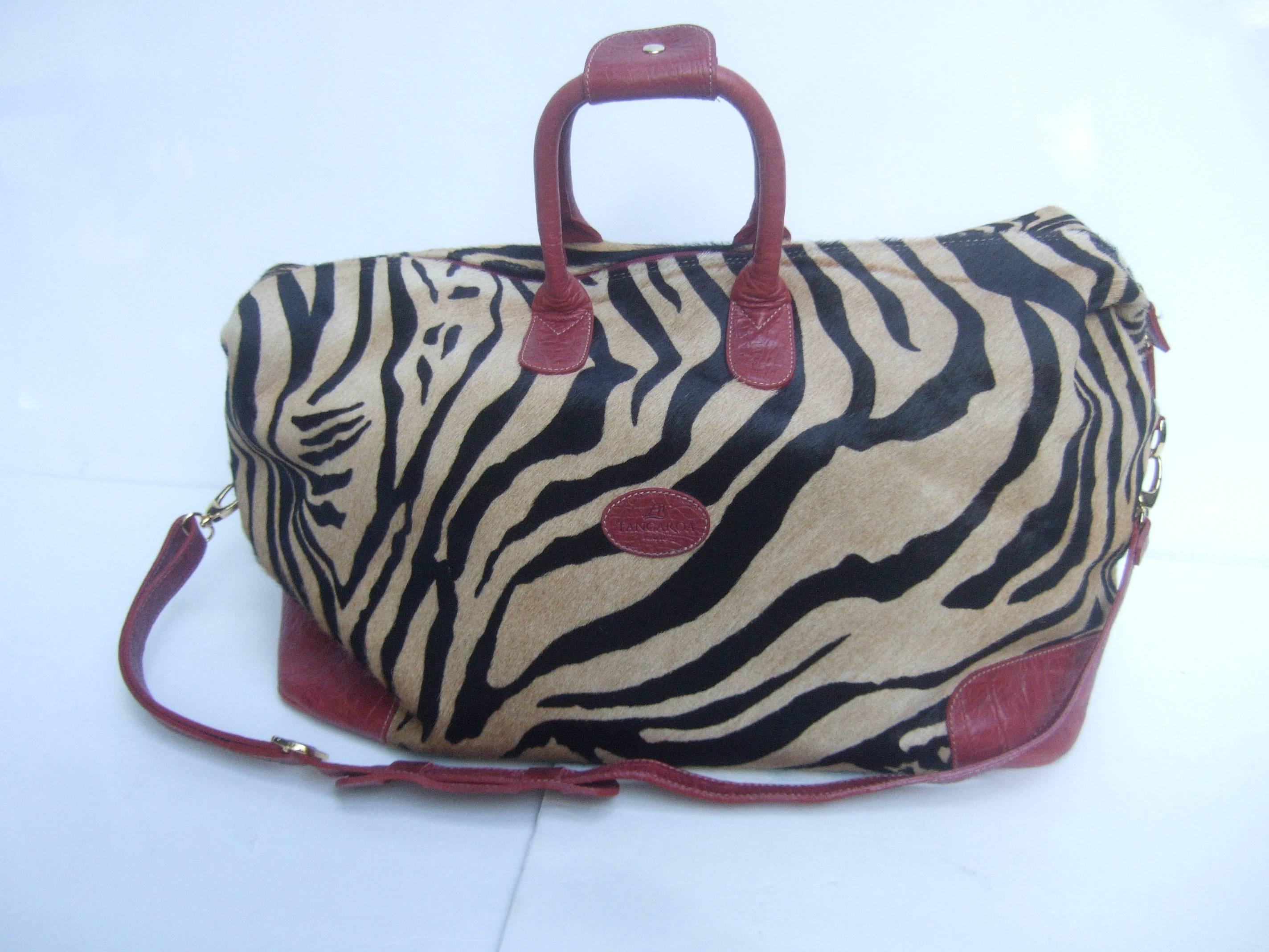 Exotic Zebra pony hair travel bag by Tangaroa Terrida Italy
The stylish travel bag is covered with animal print
pony hair on the exterior

The twin handles, shoulder strap, corners and
base of the Italian carry on travel bag are
accented with