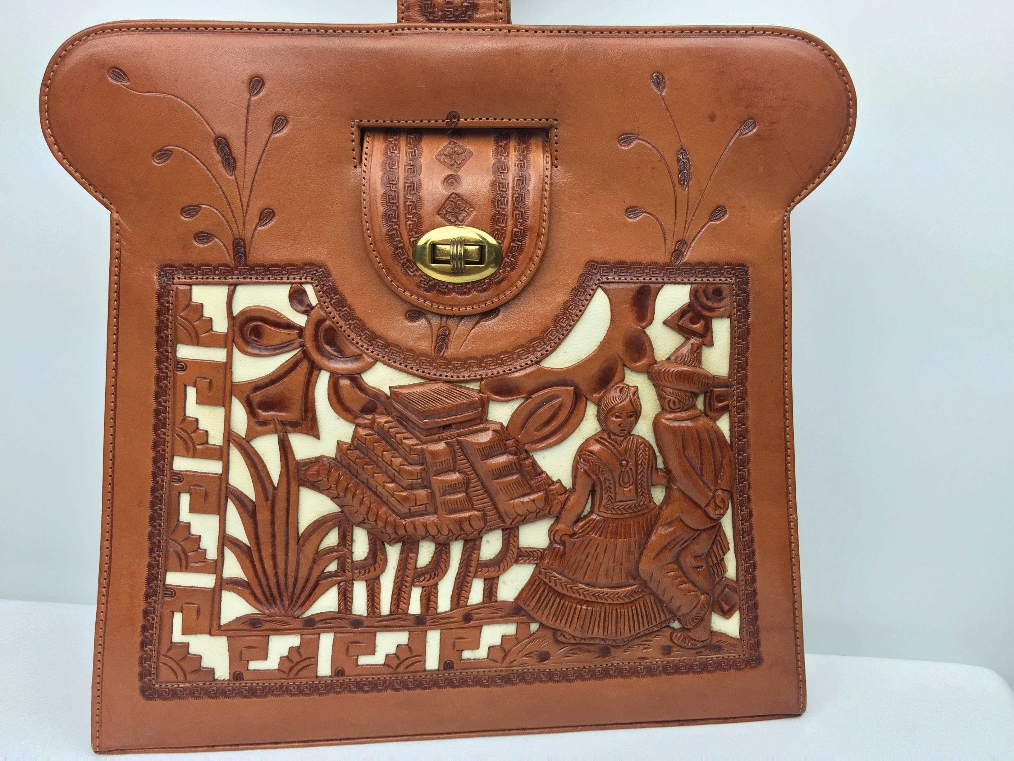 
This is such a unusual and interesting handbag.

Carefully handmade in Mexico in the 1950's and barely carried since then.

Honey colored leather with amazing decorations and a story to tell!

Narrative vintage bags like this are few and far