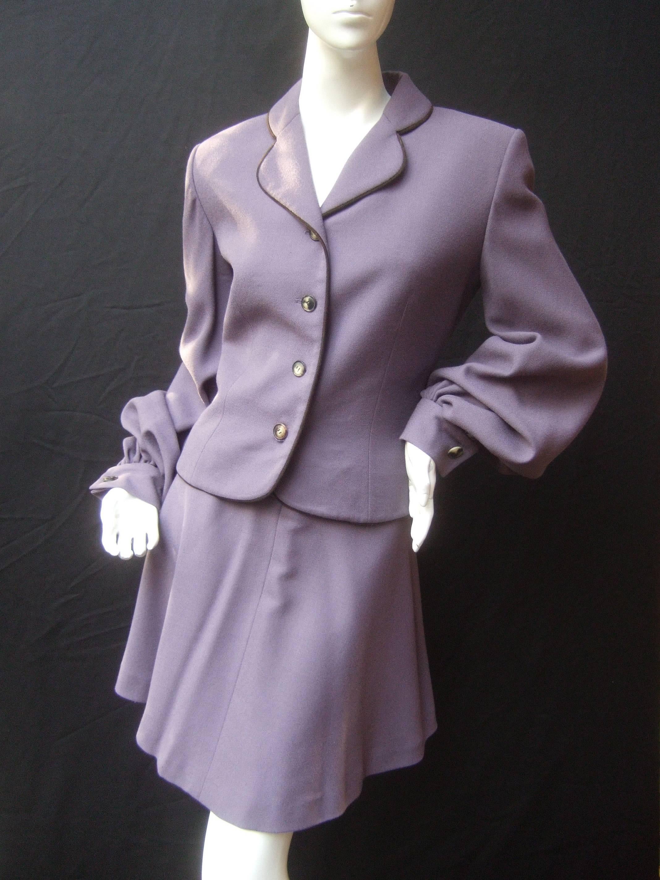 Givenchy Couture Lavender wool skirt suit Size 38
The chic pastel laine wool skirt suit is designed 
with a lavender jacket with four resin horn
buttons that run down the front

The jacket sleeves are voluminous with
subtle pleats that circle