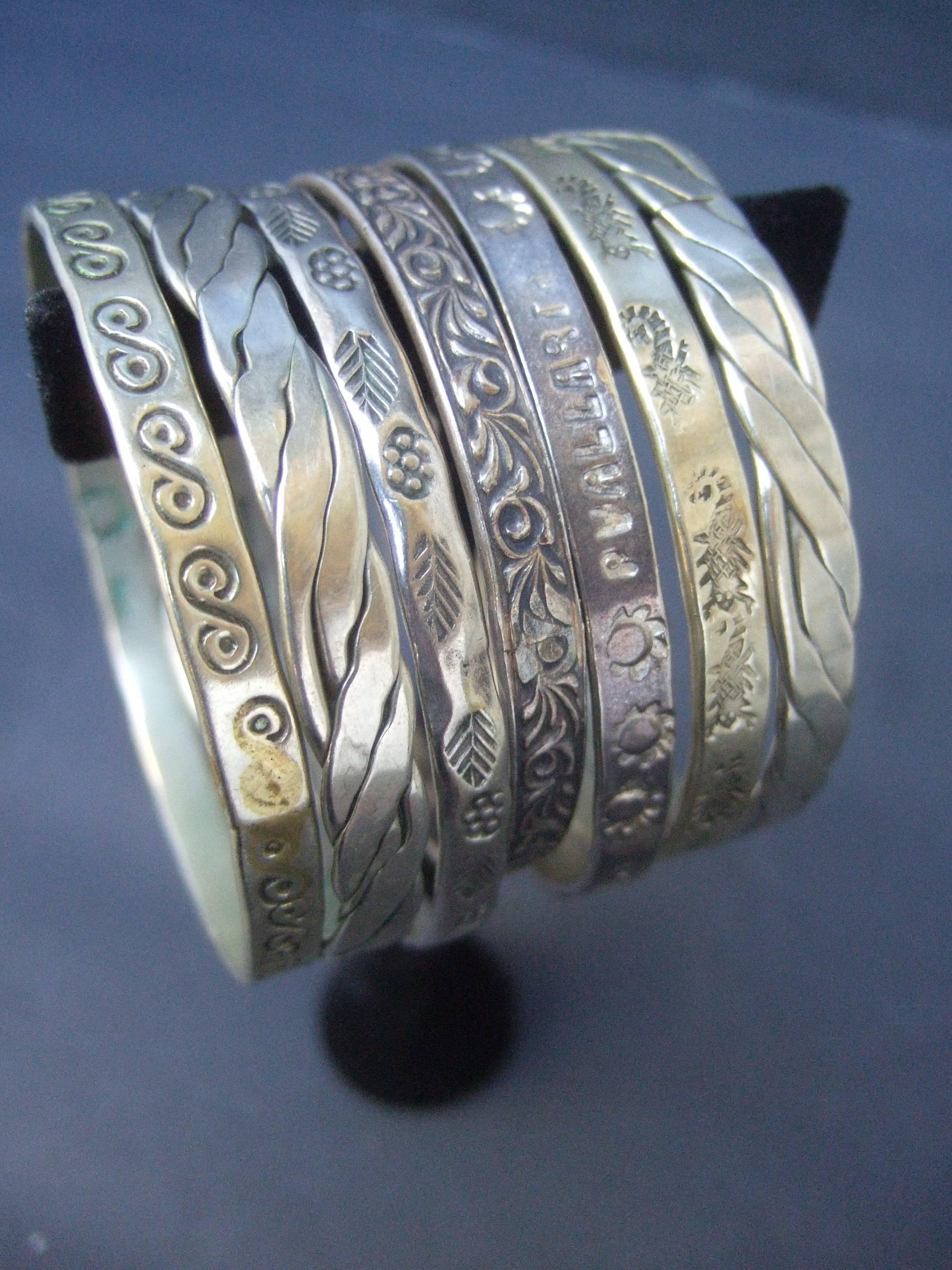 Wonderful group of Mexican sterling bangle bracelets 
The collection of seven vintage artisan bracelets 
are designed with various stamped designs and
styles

The trendy bracelets can be worn all together
or in smaller amounts or divided on