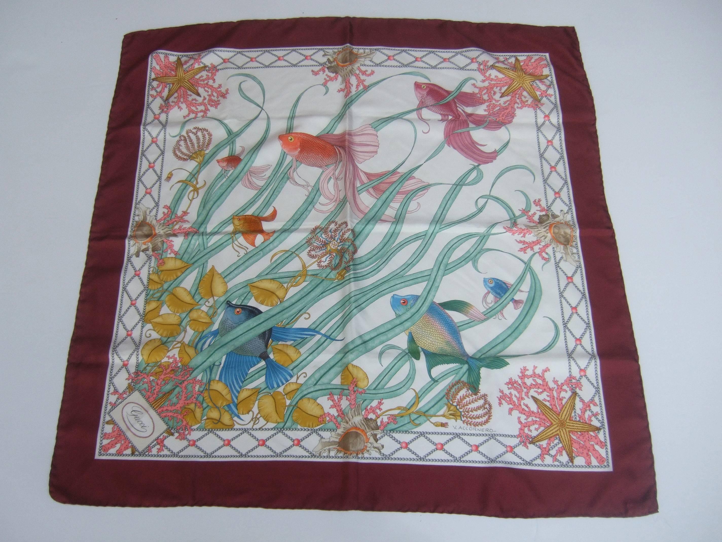 Gucci Italy Luxurious large sea life illustrated scarf 
The elegant sumptuous silk scarf is designed
with schools of tropical fish navigating thru
sinuous green foliage

The exotic fish are surrounded by conch 
shells, coral branches and