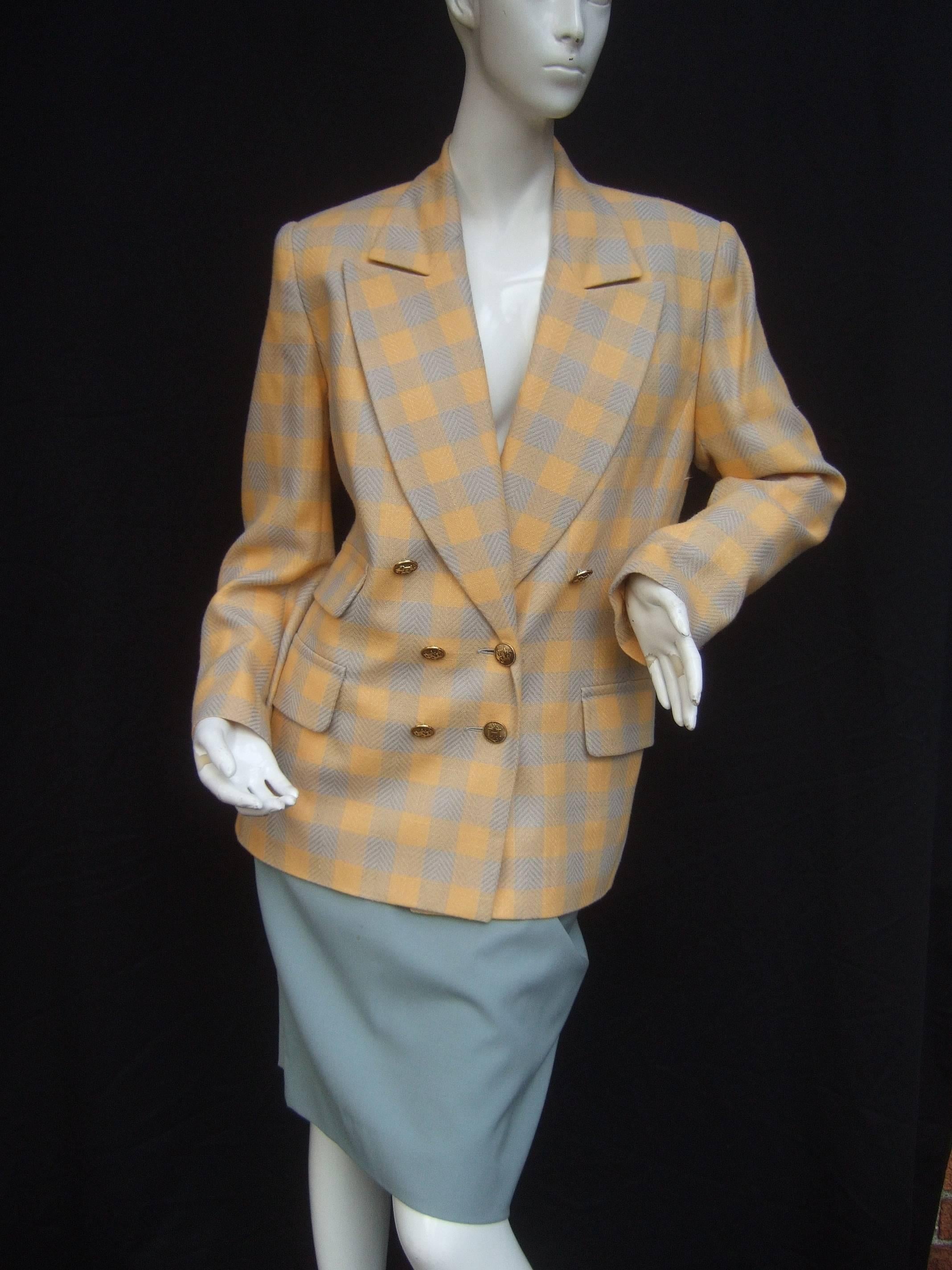 Hermes Paris Plaid wool skirt suit Size 38/ 40 c 1980
The stylish retro skirt suit is designed with 
a plaid yellow / grey double breasted silk
wool blend jacket 

The jacket is adorned with size gilt metal
Hermes insignia H buttons on the