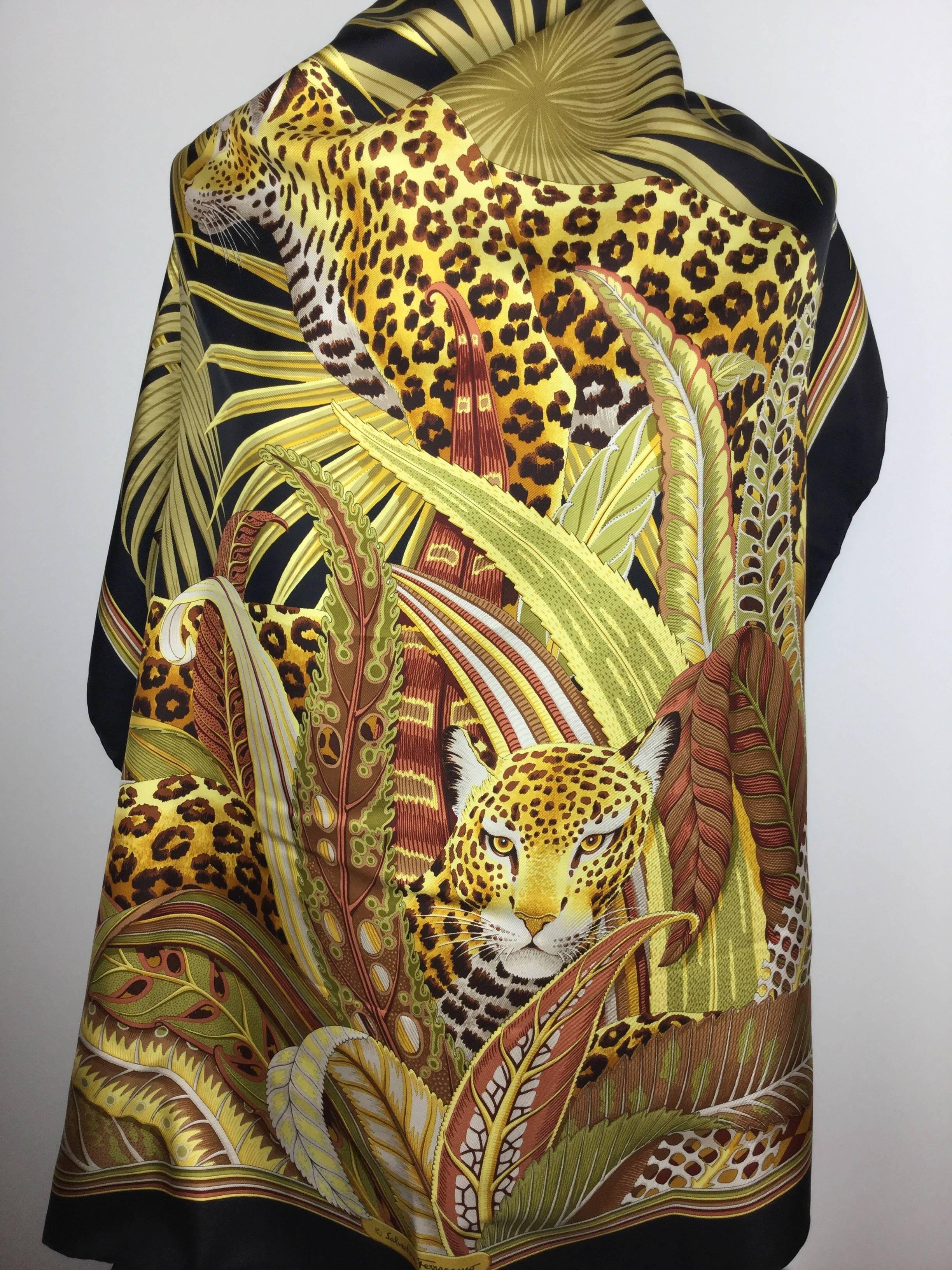 
Huge jungle themed vintage silk scarf by Salvatore Ferragamo.

Can be worn as a scarf or a shawl.

Here three leopards are rendered in incredible detail against a background
of stylized, swirling plant forms.

These big cats really engage