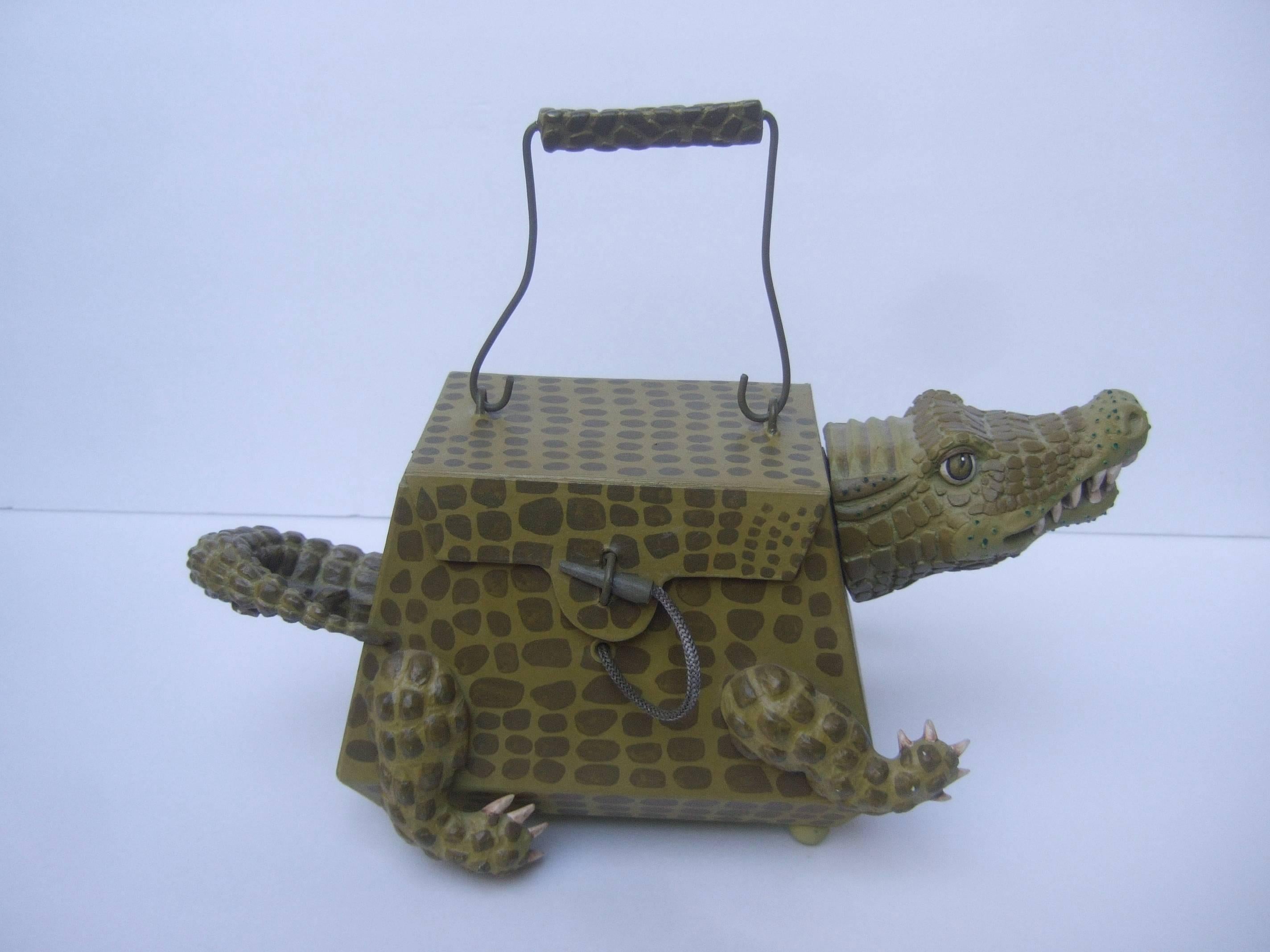 Avant-garde composition alligator handbag 
The unique handbag is designed in the shape
of a alligator. The alligator's head, tail and legs
are molded resin with textured detail that 
emulates scales

The body is constructed with light