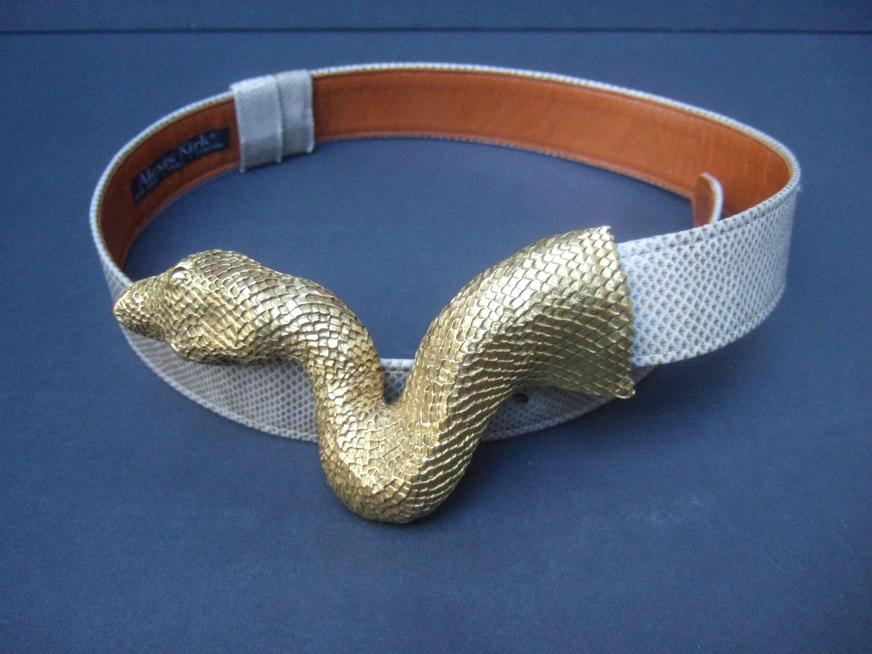Christopher Ross Exotic serpent belt buckle 
The avant-garde gilt metal buckle is designed
with a massive ornate gilt metal serpent head

The serpent has a gilt metal finish with 
etched textured detail that emulates scales   
The snake is