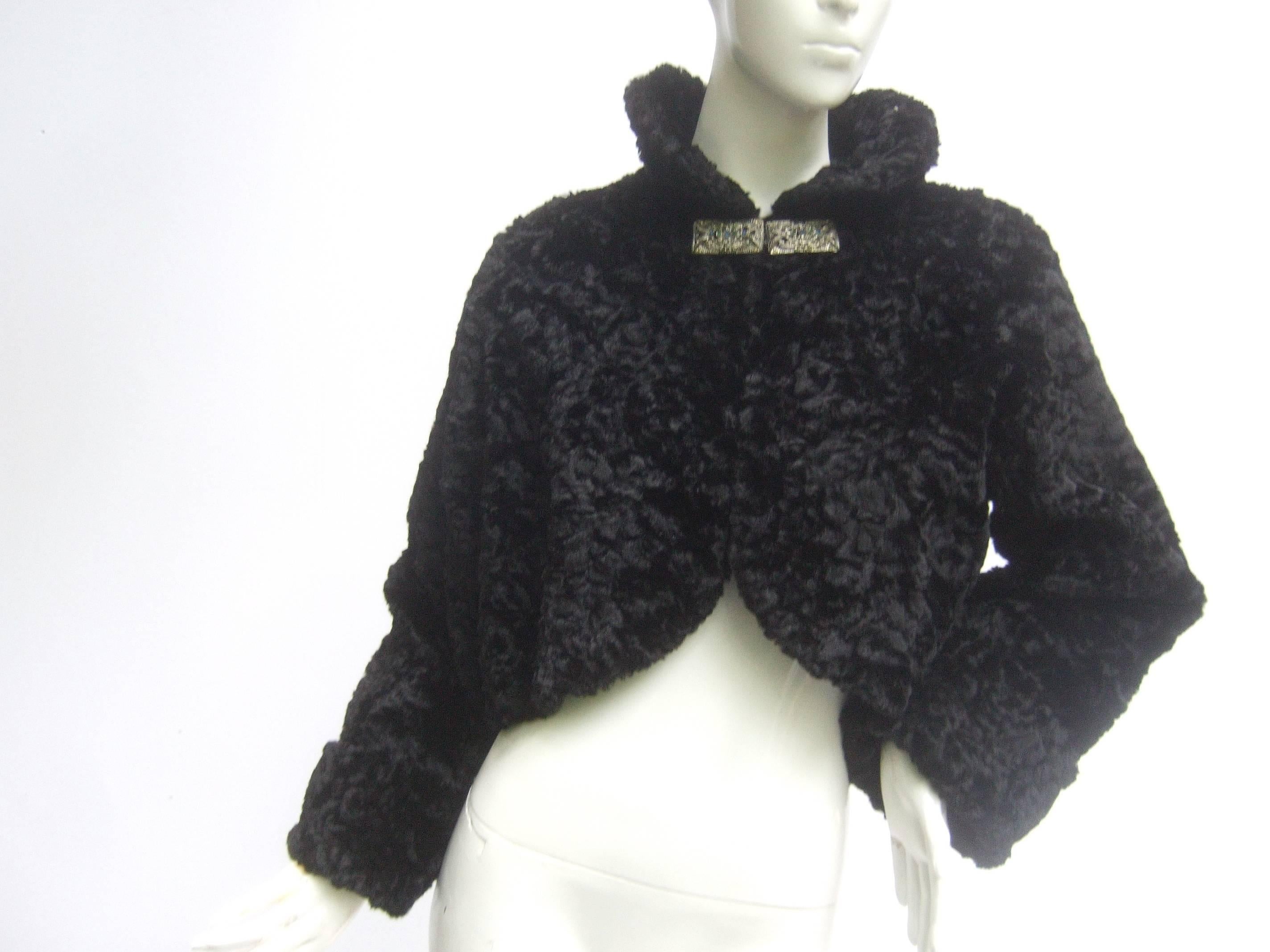 1950s Black plush mohair pile cropped jacket 
The chic retro jacket is designed with luxurious 
textured cloth pile that emulates Persian lamb fur 

The stylish jacket closes with a silver metal bar
at the collar embellished with sapphire