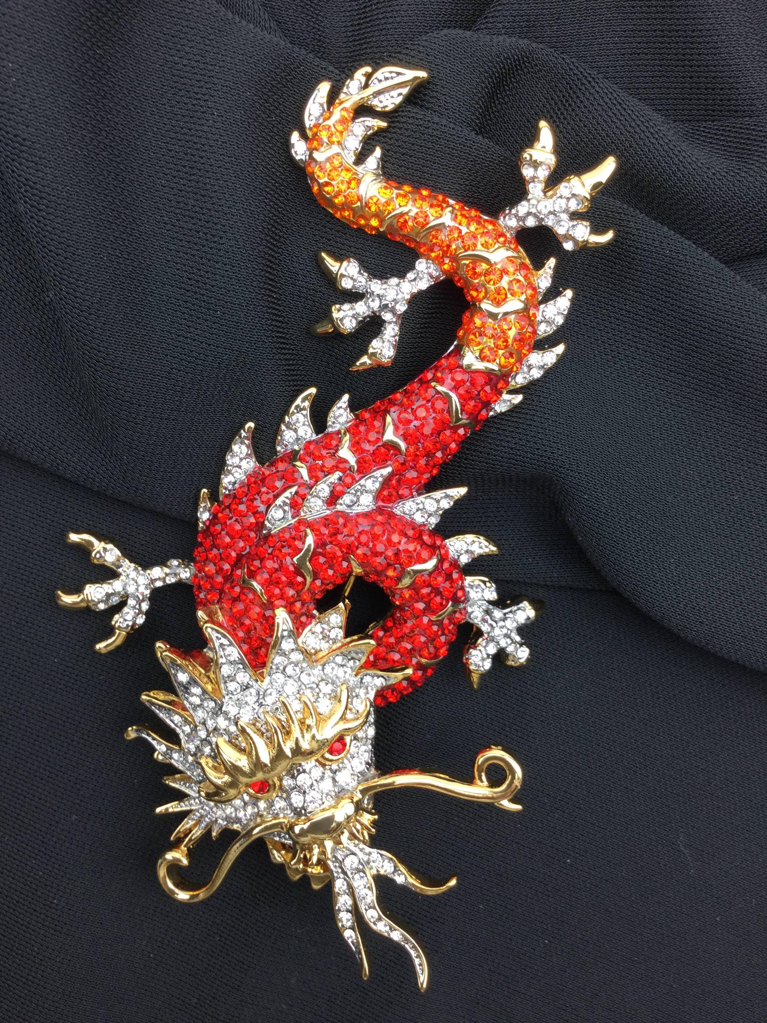 
This huge Butler and Wilson Chinese dragon Pin is just incredible!

Carpeted with tons of glittering red, orange, and clear paste crystal stones.

The design is so very pleasing and eye-catching.  The detail is superb.

Just look at that