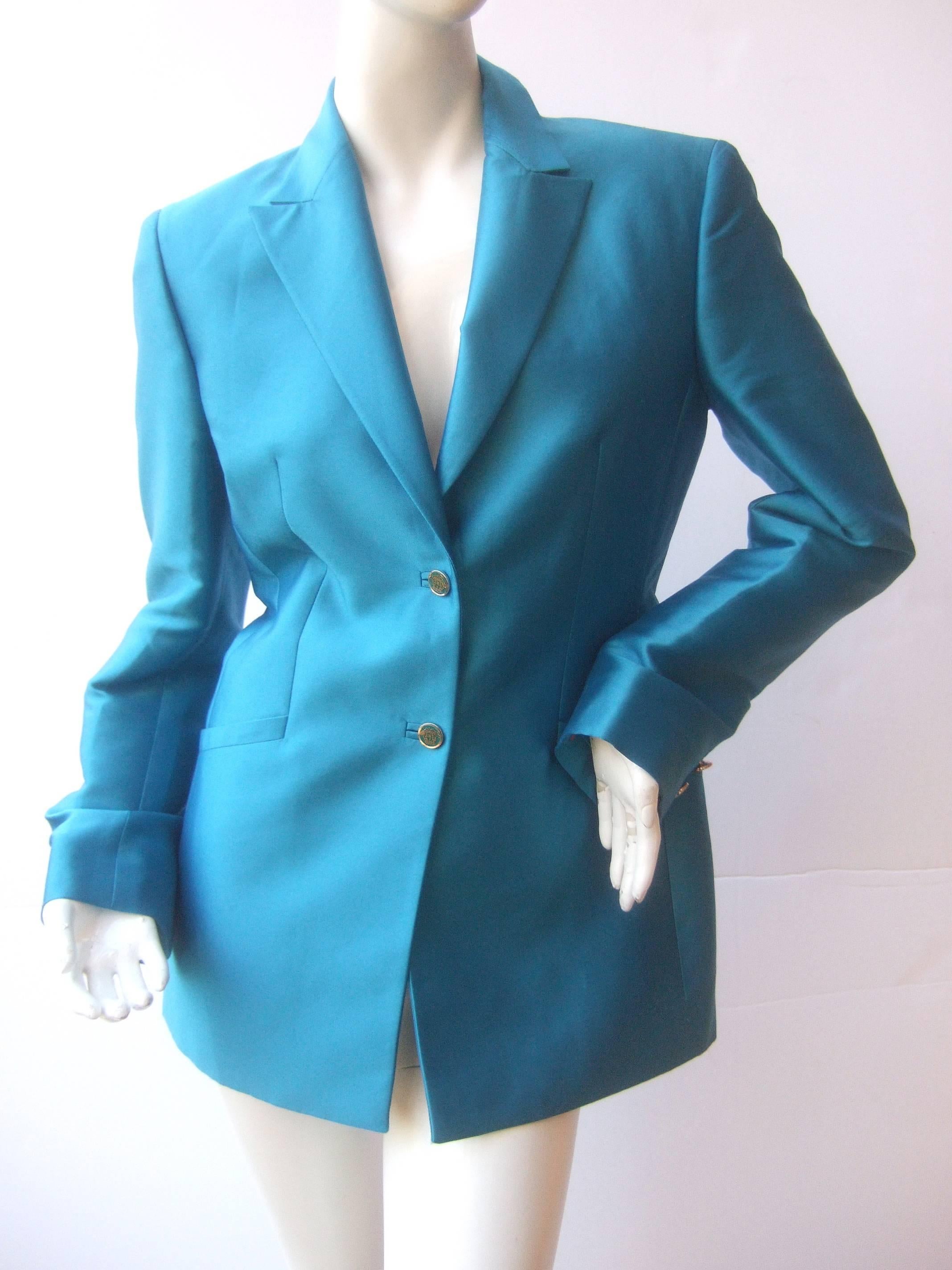 Versace Couture Turquoise silk shantung jacket 
The crisp Italian jacket is designed with luminous
aqua blue silk

The jacket is adorned with two Versace
medusa buttons on the front. The sleeve 
cuffs each have two matching medusa  
insignia