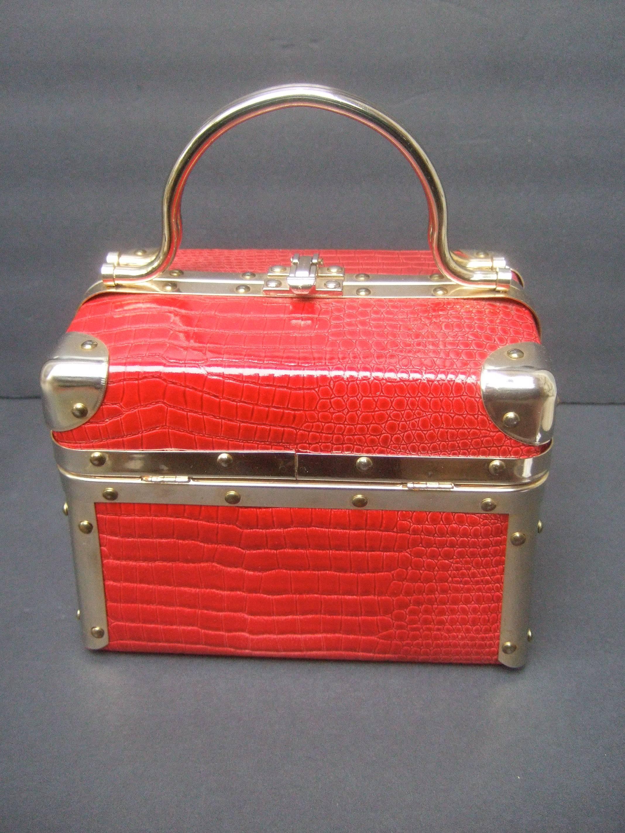 Borsa Bella Italy embossed red vinyl box bag ca 1980s
The stylish Italian box shaped handbag is designed
with sleek gilt metal hardware and trim

The embossed patent vinyl covering emulates
reptile scales. The posh handbag is carried 
with